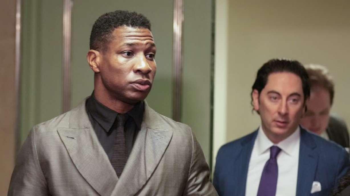Jonathan Majors, left, enters a courtroom at the Manhattan criminal courts in New York, Monday. The actor was convicted of assaulting his then-girlfriend as the two struggled over a phone in the back seat of a chauffeured car.