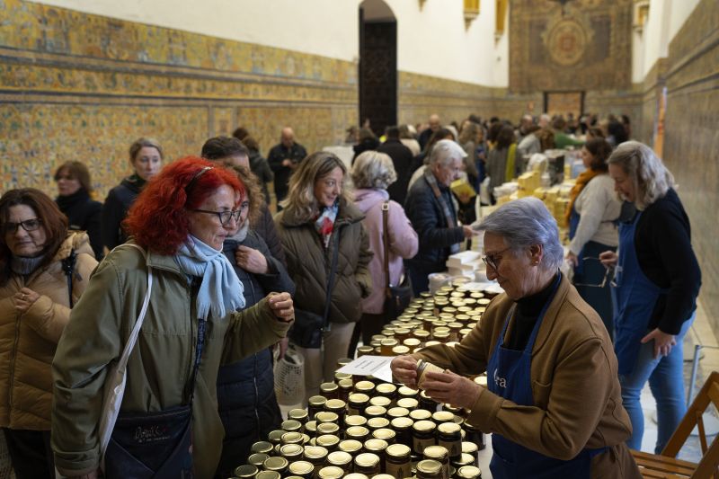 Customers buy marmalades and cakes made by cloistered nuns, at a market at the Reales Alcazares in Seville, Spain, on Dec. 5.