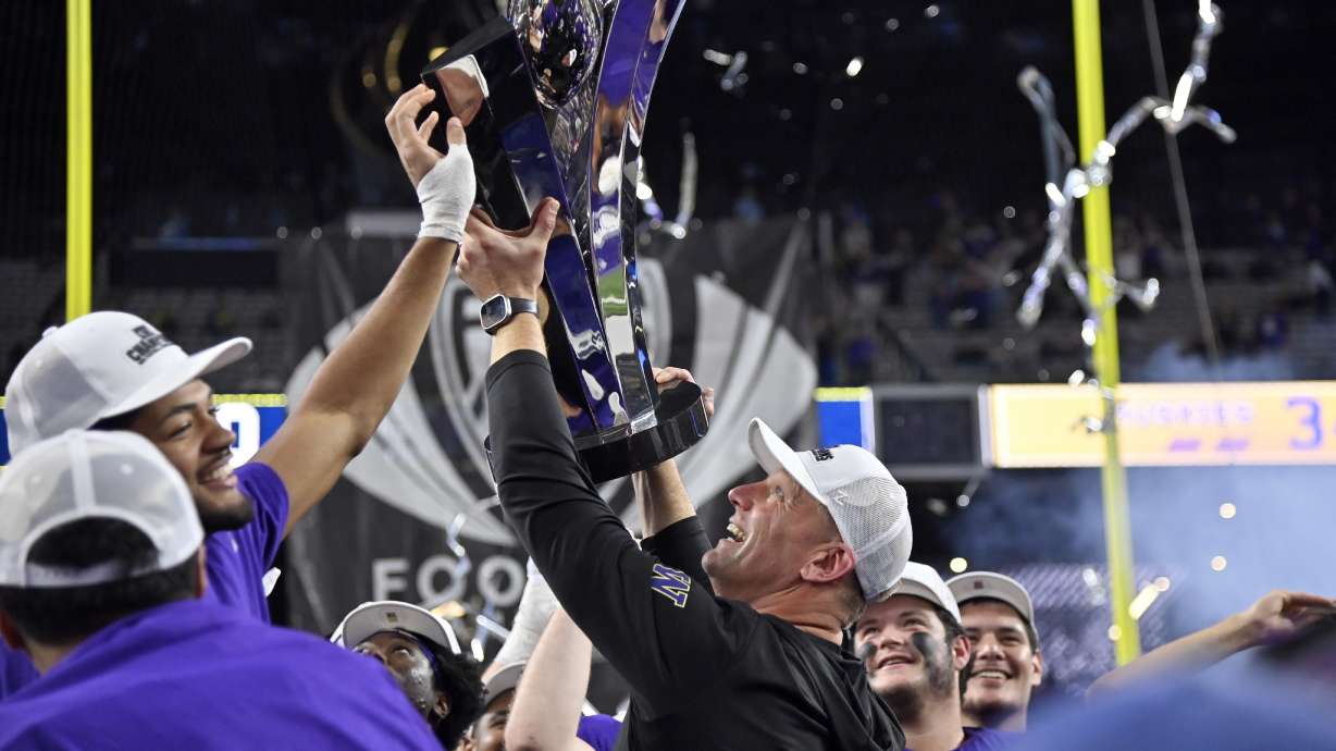Washington coach Kalen DeBoer celebrates with the trophy after the team's win over Oregon in the Pac-12 championship NCAA college football game Friday, Dec. 1, 2023, in Las Vegas.