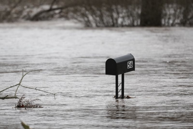 Floodwaters from the Perkiomen Creek surround a mailbox in Collegeville, Pa., Monday.