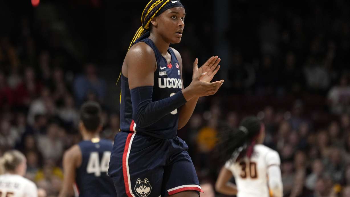 UConn forward Aaliyah Edwards claps during the first half of an NCAA college basketball game against Minnesota, Sunday, Nov. 19, 2023, in Minneapolis.
