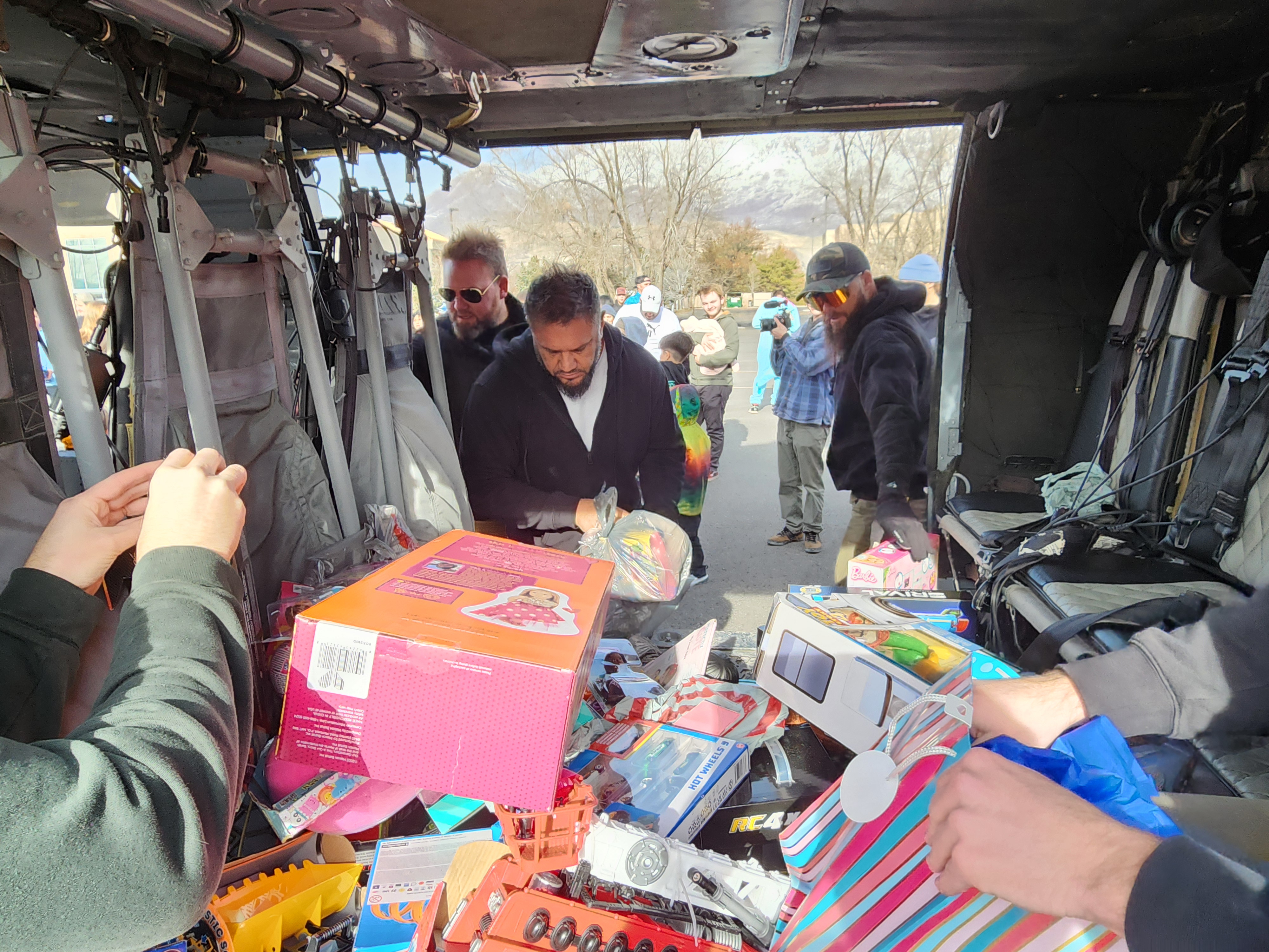 Toys being offloaded from the helicopter in Provo, as part of a charitable program to benefit children in need this Christmas.
