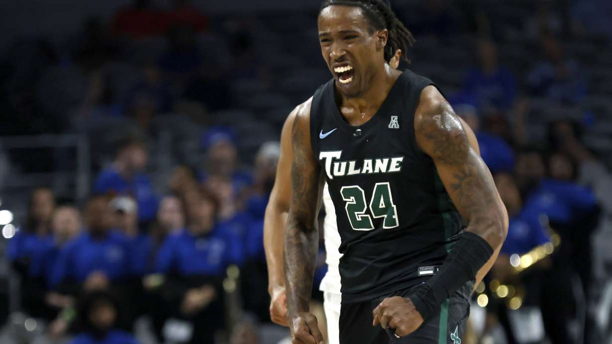 FILE - Tulane forward Kevin Cross (24) reacts after scoring a 3-point basket against Memphis during first half of an NCAA college basketball game in the semifinals of the American Athletic Conference Tournament, Saturday, March 11, 2023, in Fort Worth, Texas. Cross of Tulane is The Associated Press national player of the week after having consecutive triple-doubles against Furman and Southern last week.