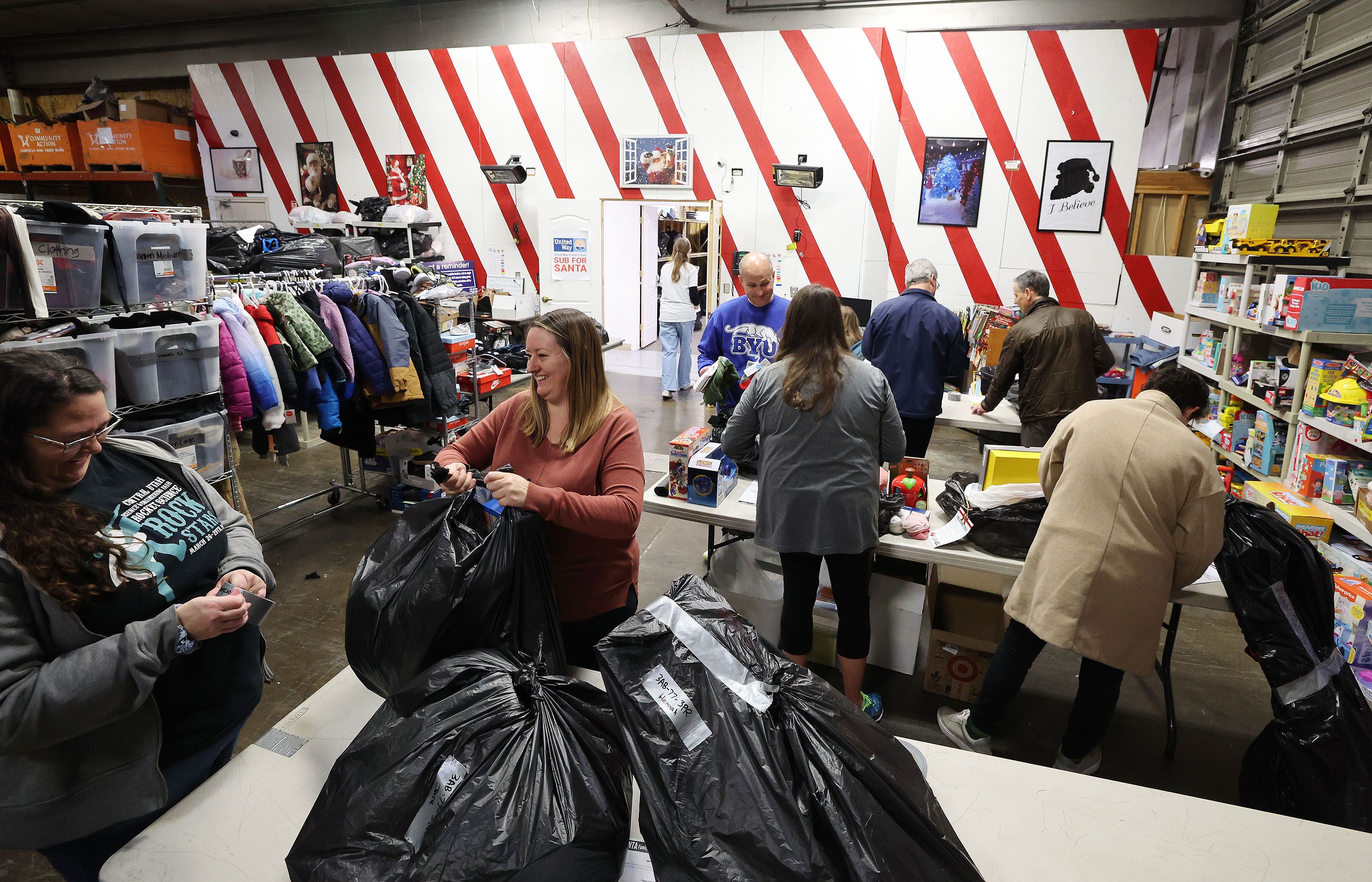 Volunteers from BYU’s McKay School of Education sort items at the United Way Sub for Santa distribution center in Provo on Tuesday.