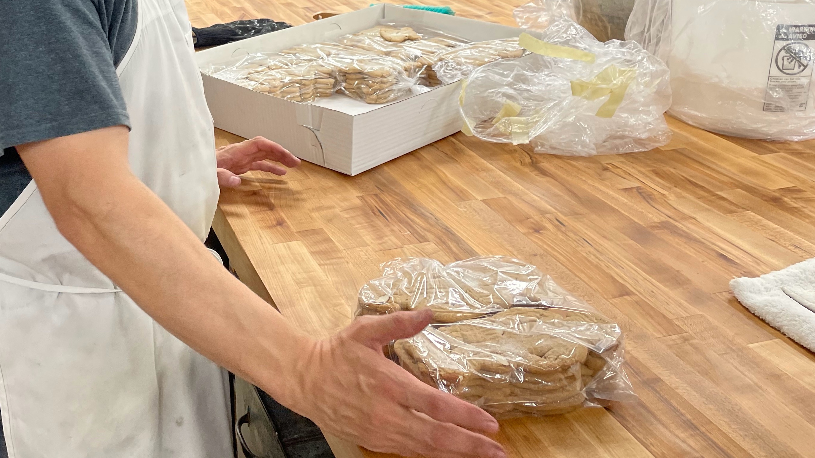 Topper Bakery operator Lance DeRyke on Monday with speculaas, one of the Dutch cookies for which the business is known. The business is not yet offering goods to the public, but operators hope to reopen next January after rebuilding from a devastating 2021 fire.