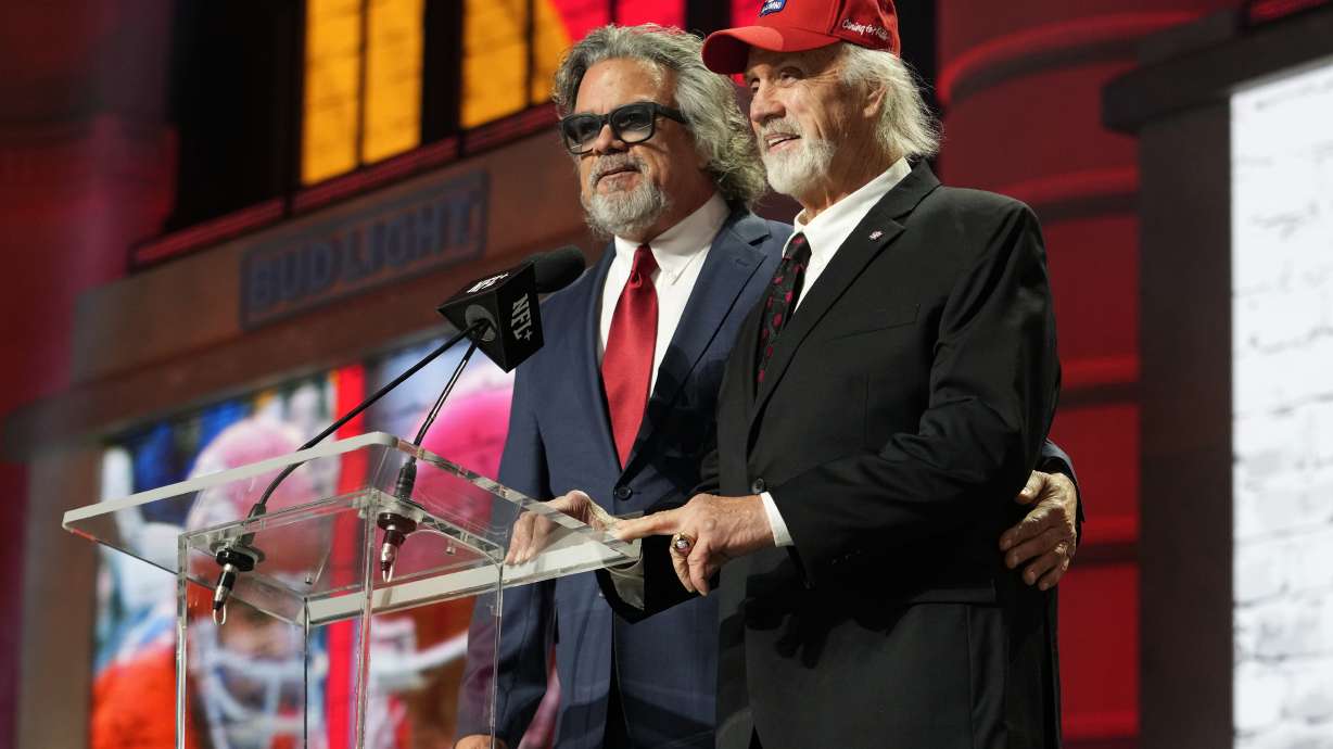FILE - Ed Budde, right, and Brad Budde announce the No. 55 pick for the Kansas City Chiefs at the NFL football draft April 28, 2023, in Kansas City, Mo. The Chiefs picked SMU wide receiver Rashee Rice. Ed Budde, who spent 14 years playing along the offensive line of the Chiefs and helped the franchise win its first Super Bowl with a victory over Minnesota in 1970, died Tuesday, Dec. 19, 2023. He was 83. The family announced his death through a statement issued by the Chiefs. No cause of death was provided.