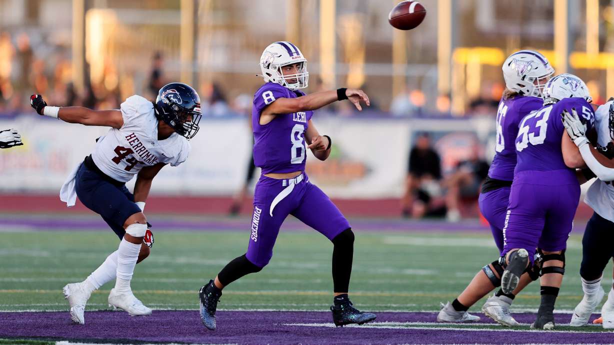 Lehi’s Jett Niu gets off a pass just ahead of Herriman’s Ephraim Asiata as the play at Lehi on Friday, Sept. 8, 2023. Lehi won 48-28.