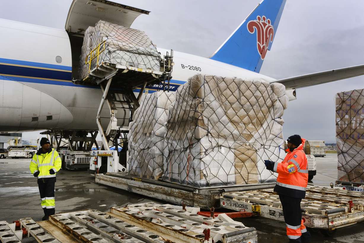 Ground crew at the Los Angeles International airport unload pallets of supplies of medical personal protective equipment, PPE, from a China Southern Cargo plane upon arrival on April 10, 2020. Some states that stockpiled millions of masks and other personal protective equipment during the coronavirus pandemic are now throwing the items away.