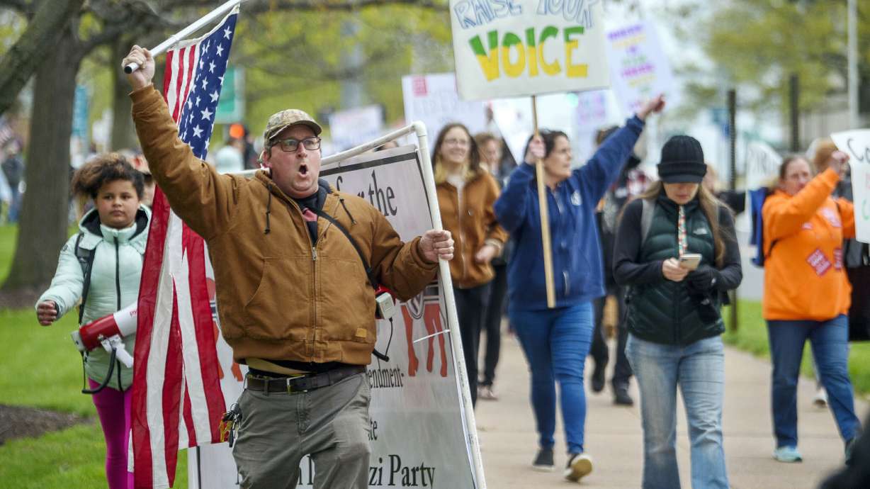 Opponents of a bill to repeal Connecticut's religious exemption for required school vaccinations march down Capitol Avenue before the state Senate voted on legislation on April 27, 2021, in Hartford, Conn. Parents are opting out of school vaccinations at the highest rate ever.