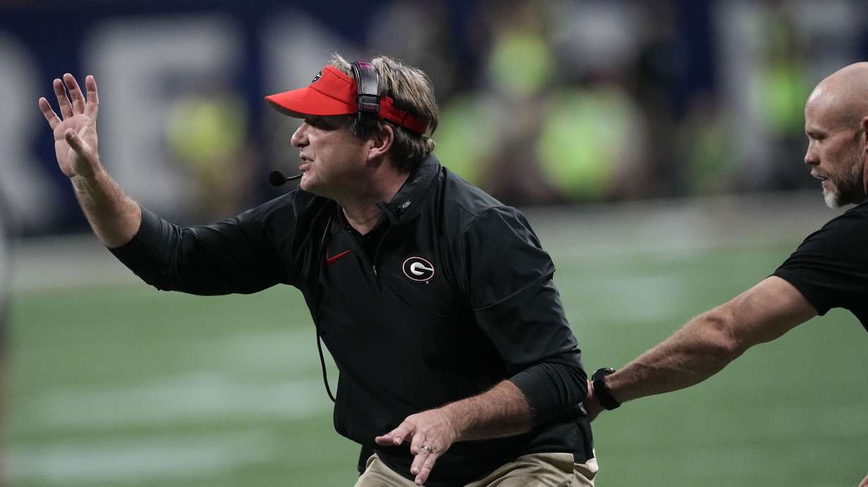 Georgia head coach Kirby Smart talks to players during the first half of the Southeastern Conference championship NCAA college football game against Alabama in Atlanta, Saturday, Dec. 2, 2023.