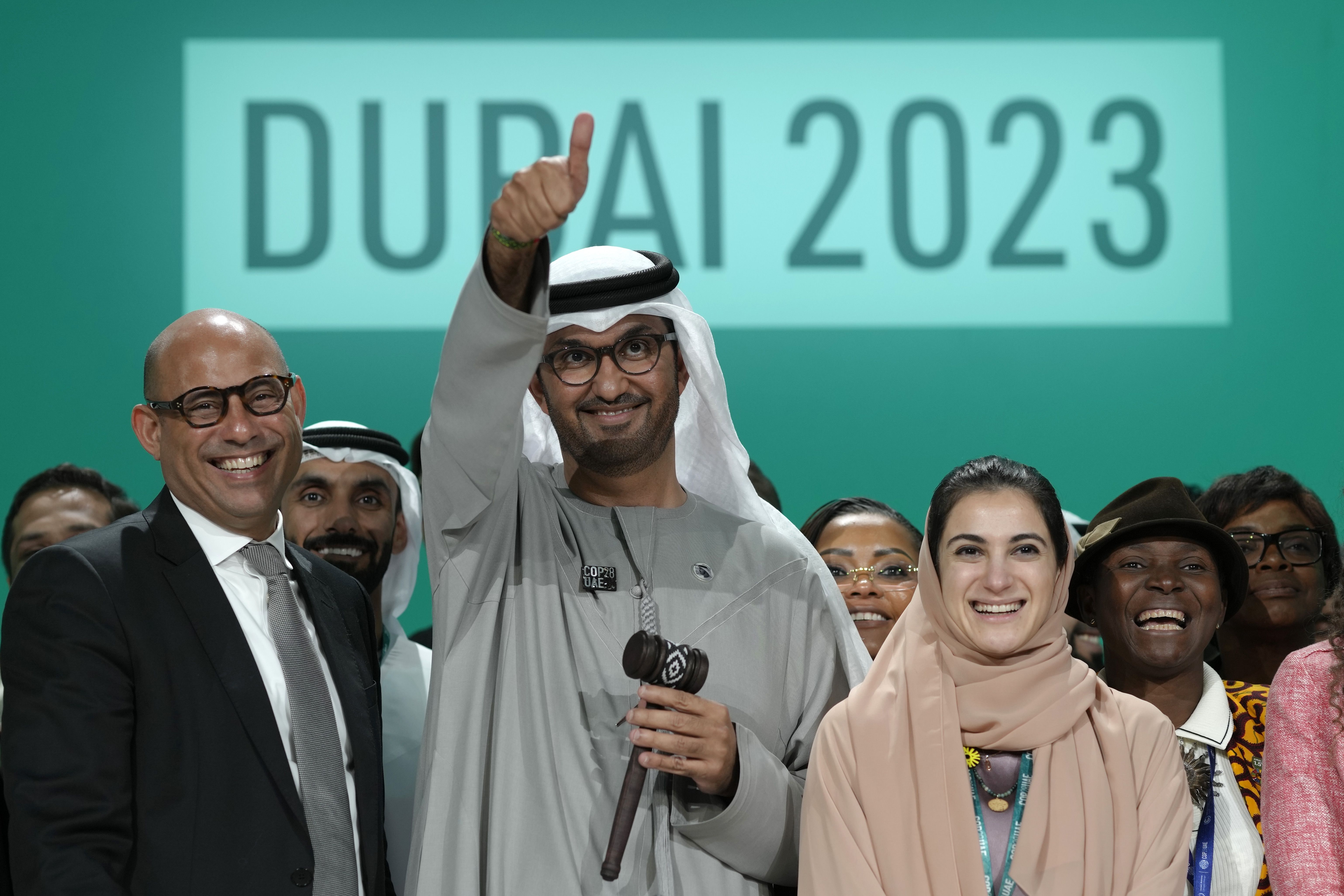 United Nations Climate Chief Simon Stiell, from left, COP28 President Sultan al-Jaber and Hana Al-Hashimi, chief COP28 negotiator for the United Arab Emirates, pose for photos at the end of the COP28 U.N. Climate Summit on Dec. 13, in Dubai, United Arab Emirates.