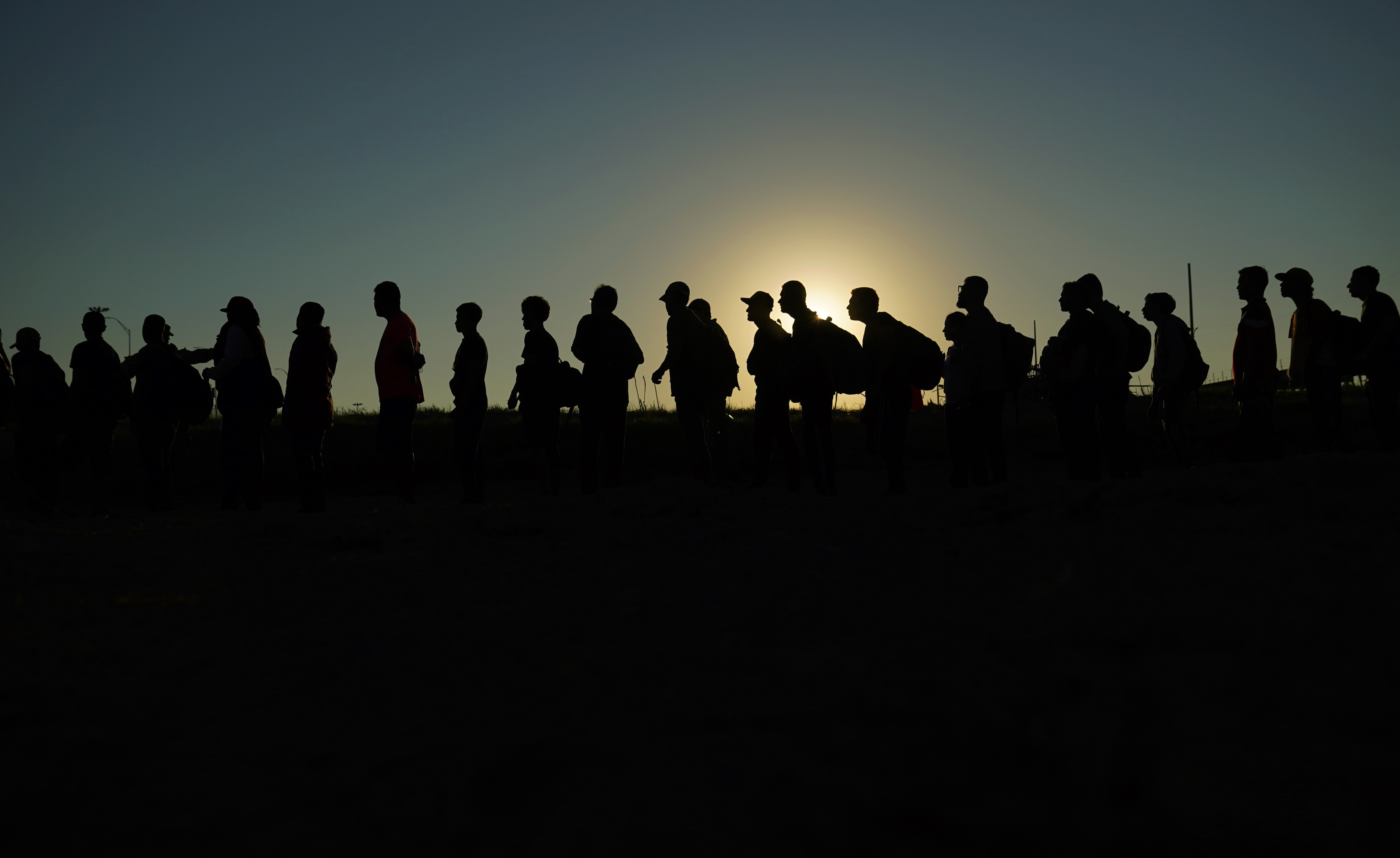 Migrants are lined up for processing by U.S. Customs and Border Protection on Sept. 23, 2023, in Eagle Pass, Texas. Texas has begun flying migrants from the U.S.-Mexico border to Chicago.