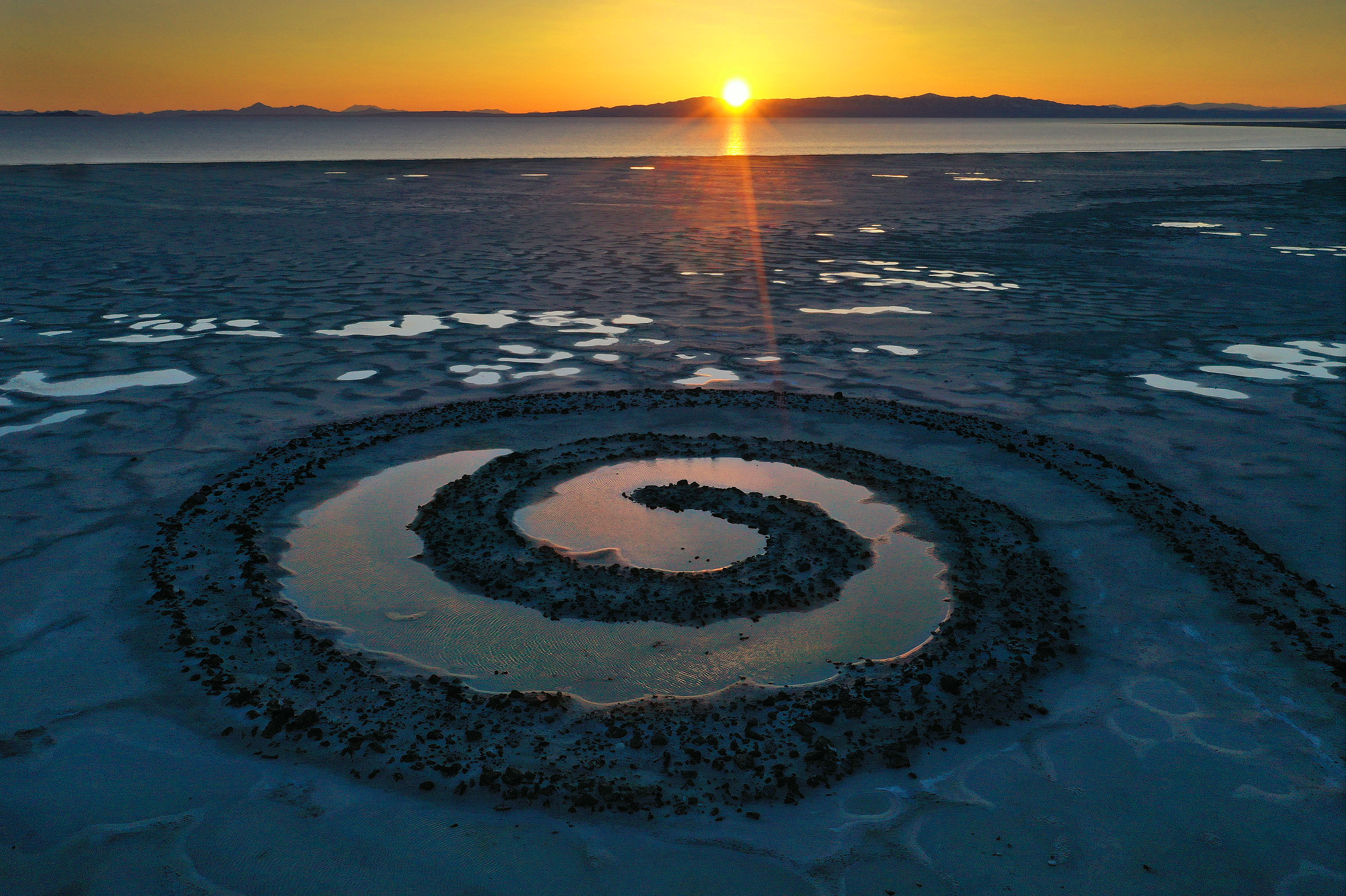 The sun sets on the Spiral Jetty on the Great Salt Lake on Thursday, March 16.