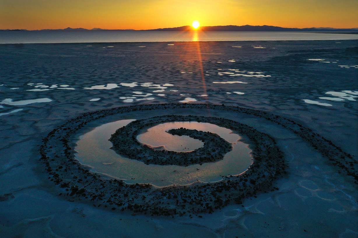 The sun sets on the Spiral Jetty on the Great Salt Lake on March 16, 2023.