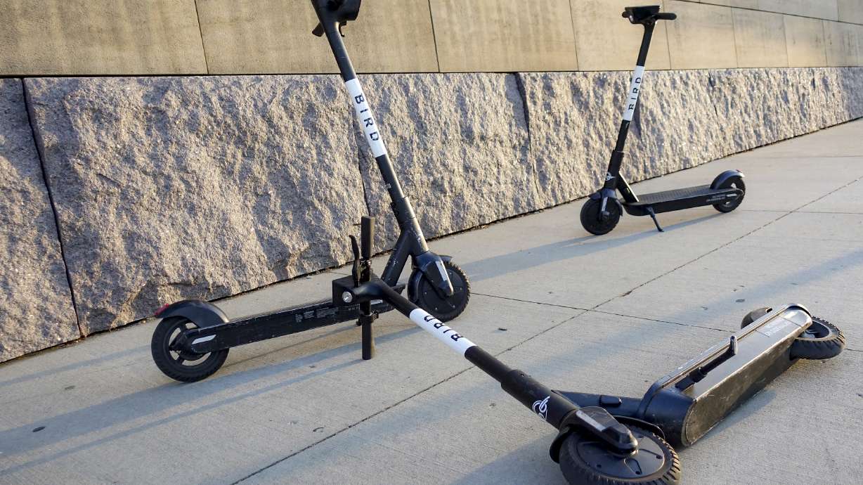 Sharable electric scooters by Bird Rides wait on downtown sidewalks for pedestrian use, Oct. 2, 2019, in downtown Cincinnati. Electric scooter company Bird Global announced Wednesday that it has filed for bankruptcy protection.