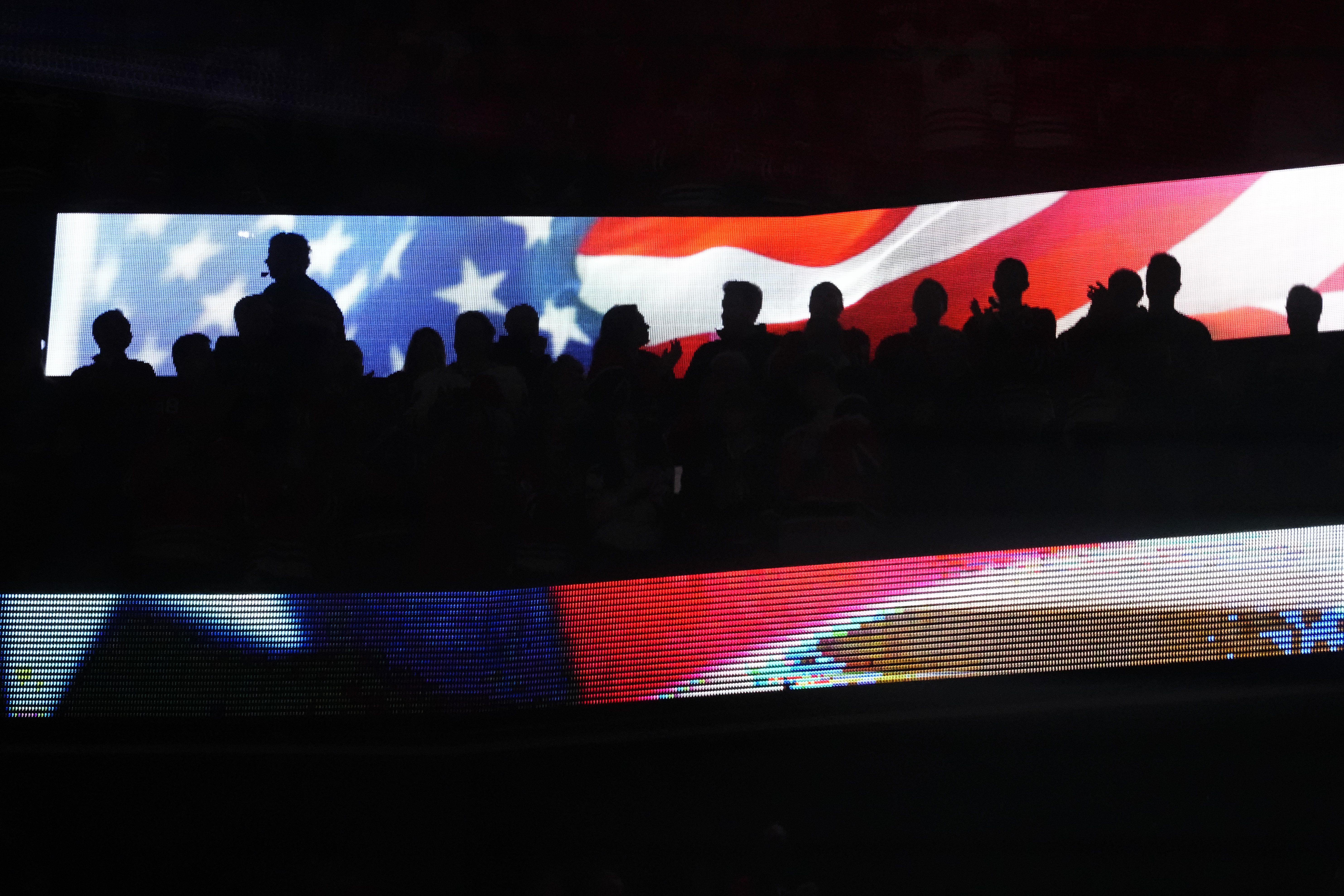 Fans at United Center stand for the national anthem before an NHL hockey game between the Vancouver Canucks and the Chicago Blackhawks in Chicago, Sunday, Dec. 17, 2023.