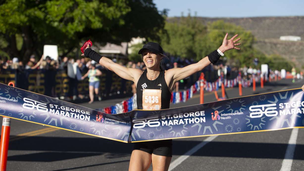 A St. George Marathon runner crosses the finish line, Oct. 7. The event draws people from all over, bringing a reported $10.4 million boon to the economy.