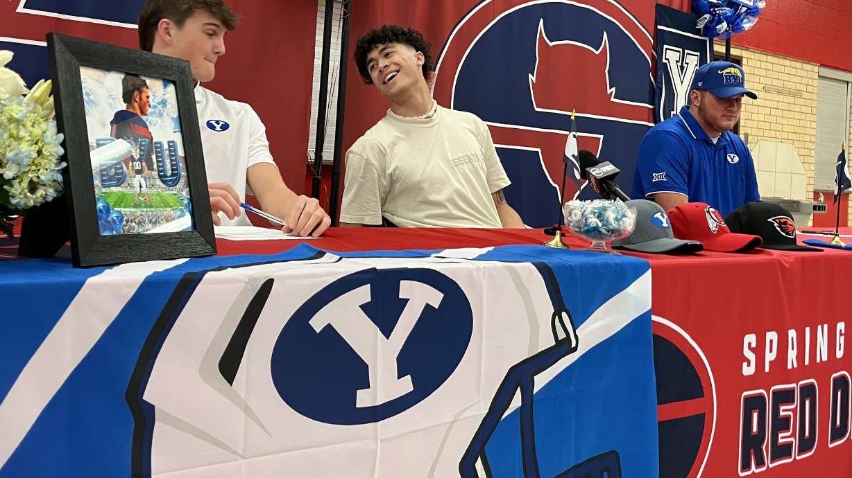 BYU commit Dallin Johnson, far right, with Springville High teammates Kinilau Fonohema and Luke Nadauld before Fonohema committed to BYU on the first day of the NCAA's early signing period, Wednesday, Dec. 20, 2023, in Springville, Utah.