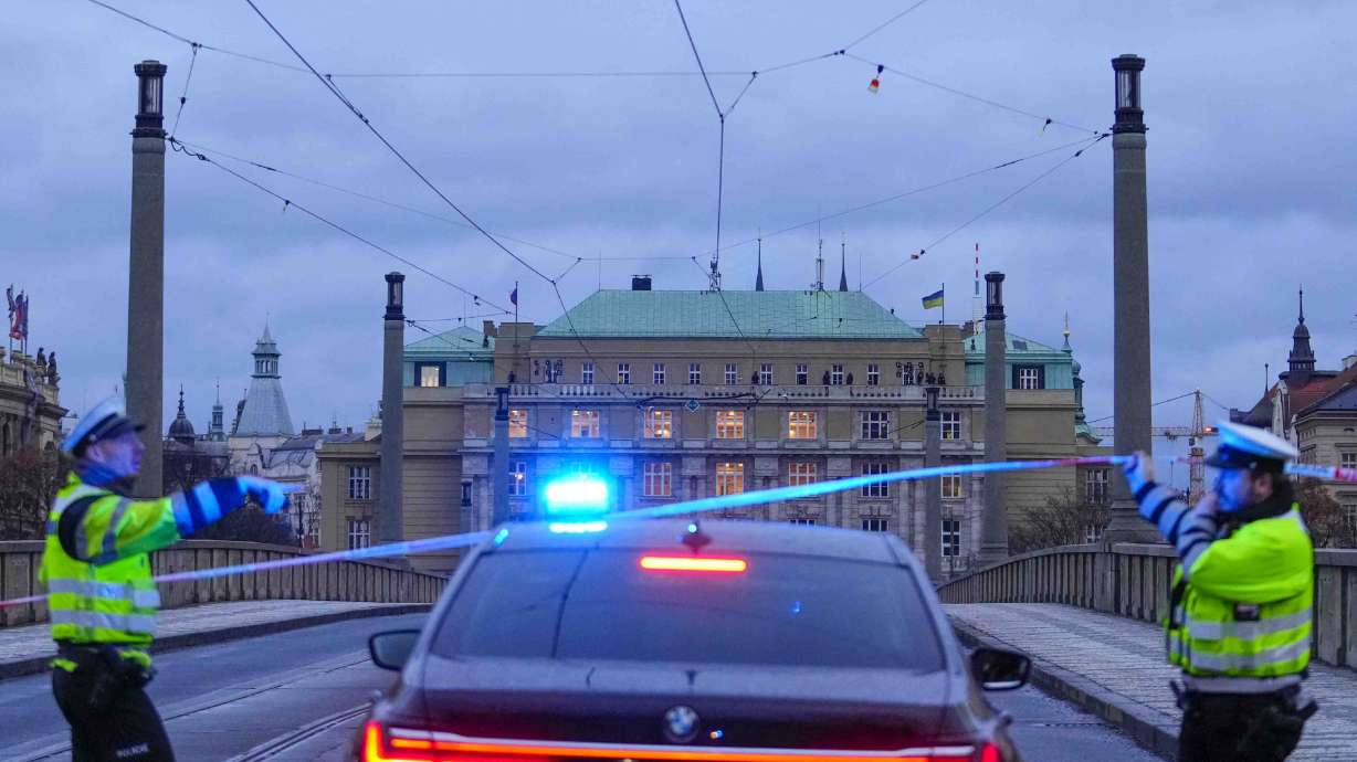 Police officers guard a street in downtown Prague, Czech Republic, Thursday. Czech police say a shooting in downtown Prague has killed 14 people and wounded 25 others.
