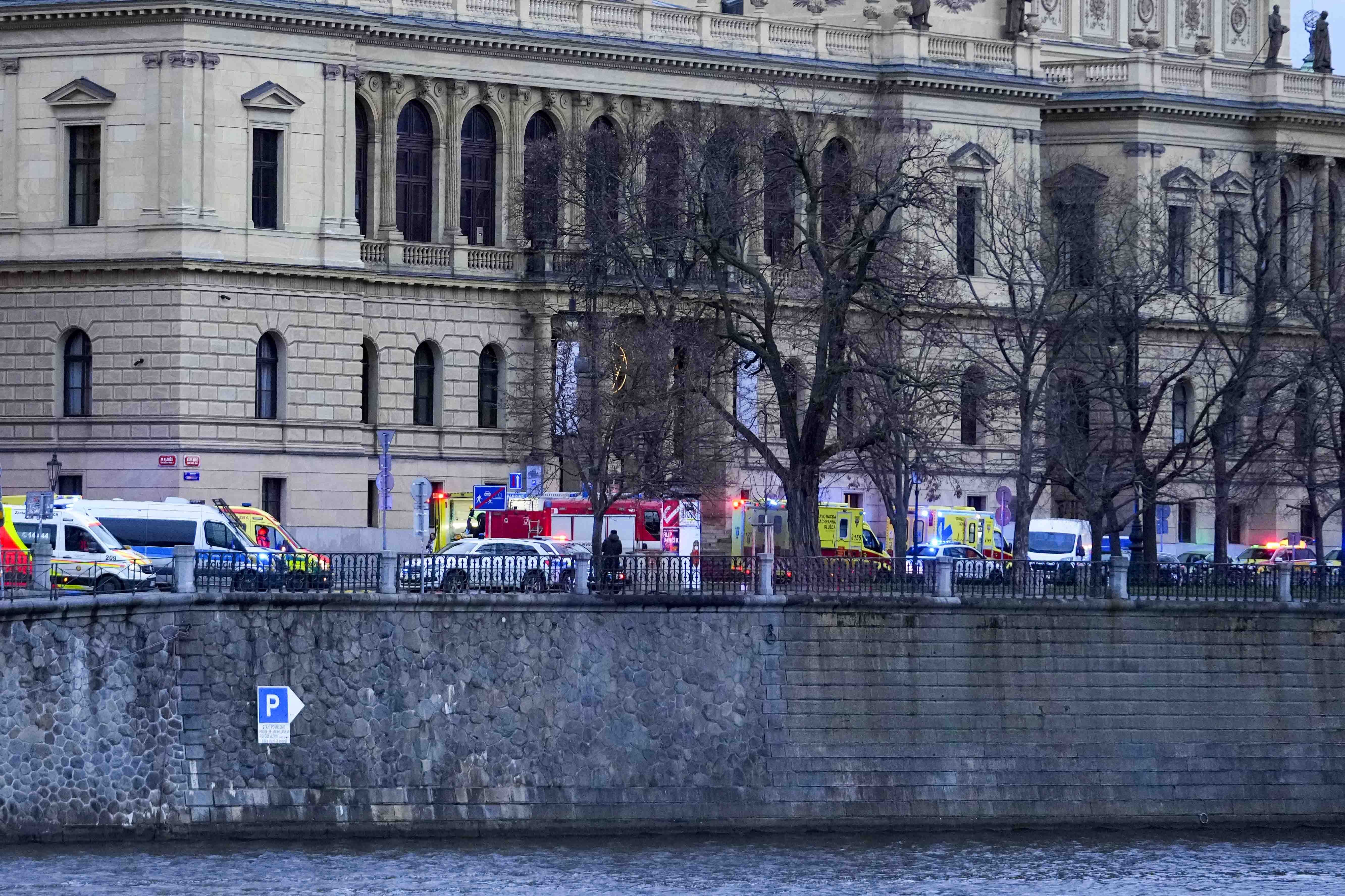 Police officers secure an area after a shooting in downtown Prague, Czech Republic, Thursday. Czech police say a shooting in downtown Prague has killed 14 people and wounded 25 others.