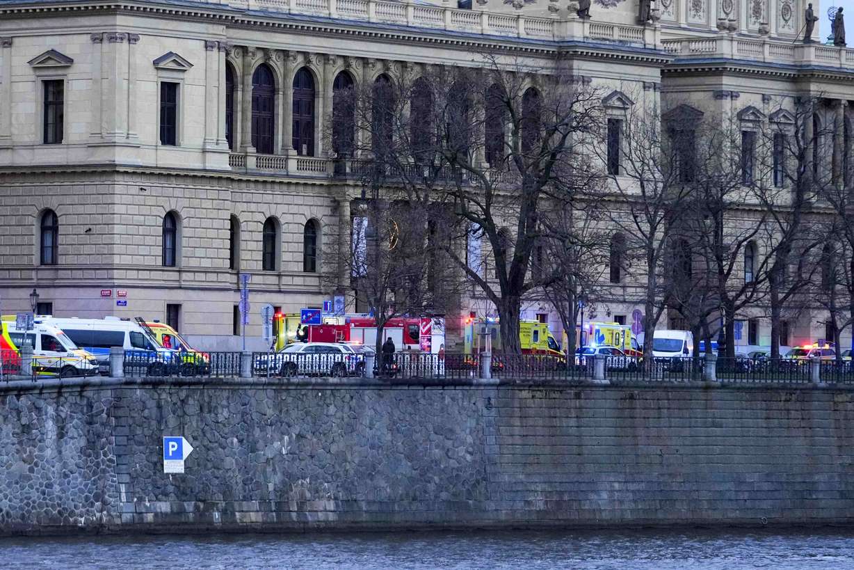 Police officers secure an area after a shooting in downtown Prague, Czech Republic, Thursday. Czech police say a shooting in downtown Prague has killed 14 people and wounded 25 others.