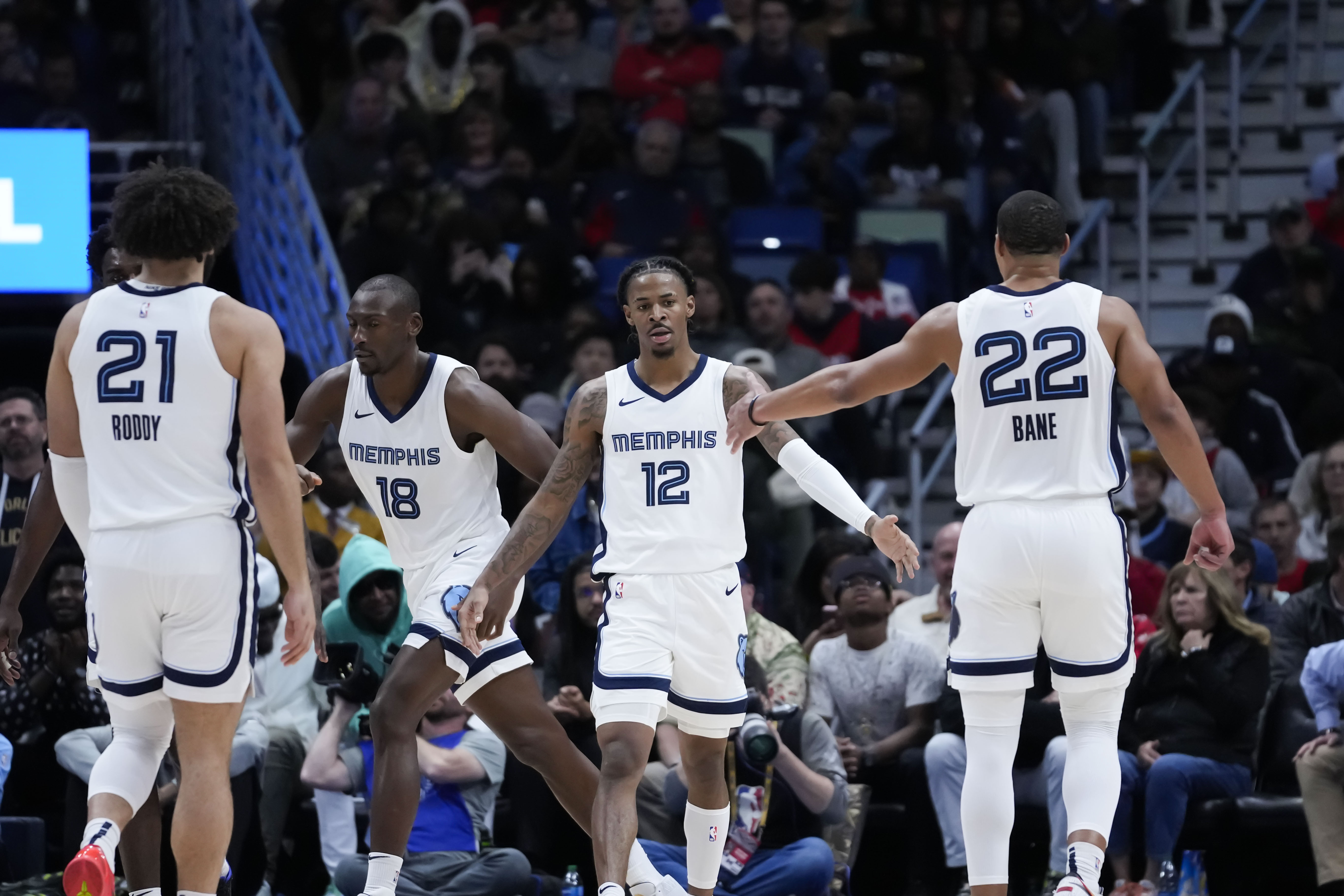 Memphis Grizzlies guard Ja Morant (12) celebrates with teammates in the second half of an NBA basketball game against the New Orleans Pelicans in New Orleans, Tuesday, Dec. 19, 2023. The Grizzlies won 115-113. 