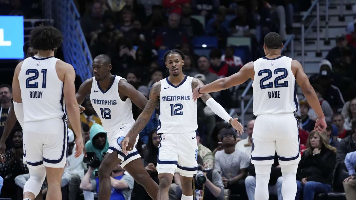 Memphis Grizzlies guard Ja Morant (12) celebrates with teammates in the second half of an NBA basketball game against the New Orleans Pelicans in New Orleans, Tuesday, Dec. 19, 2023. The Grizzlies won 115-113.