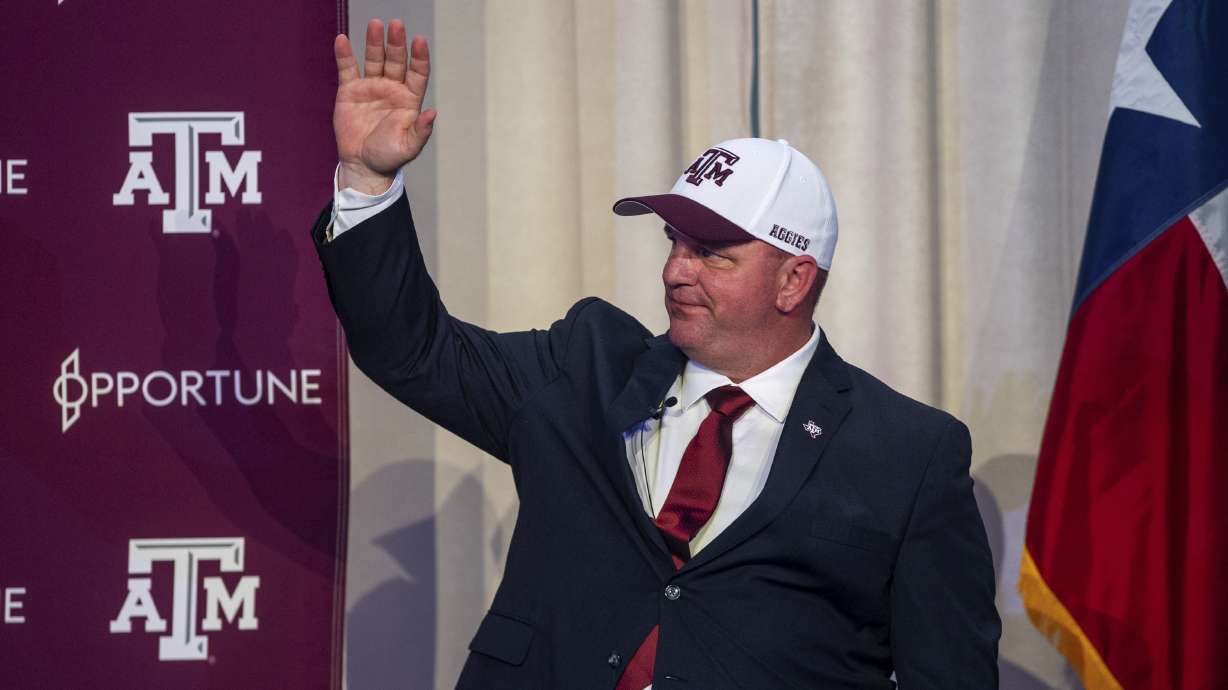 Newly appointed Texas A&M head coach Mike Elko waves during a welcome celebration in his honor on Monday, Nov. 27, 2023, in College Station, Texas.