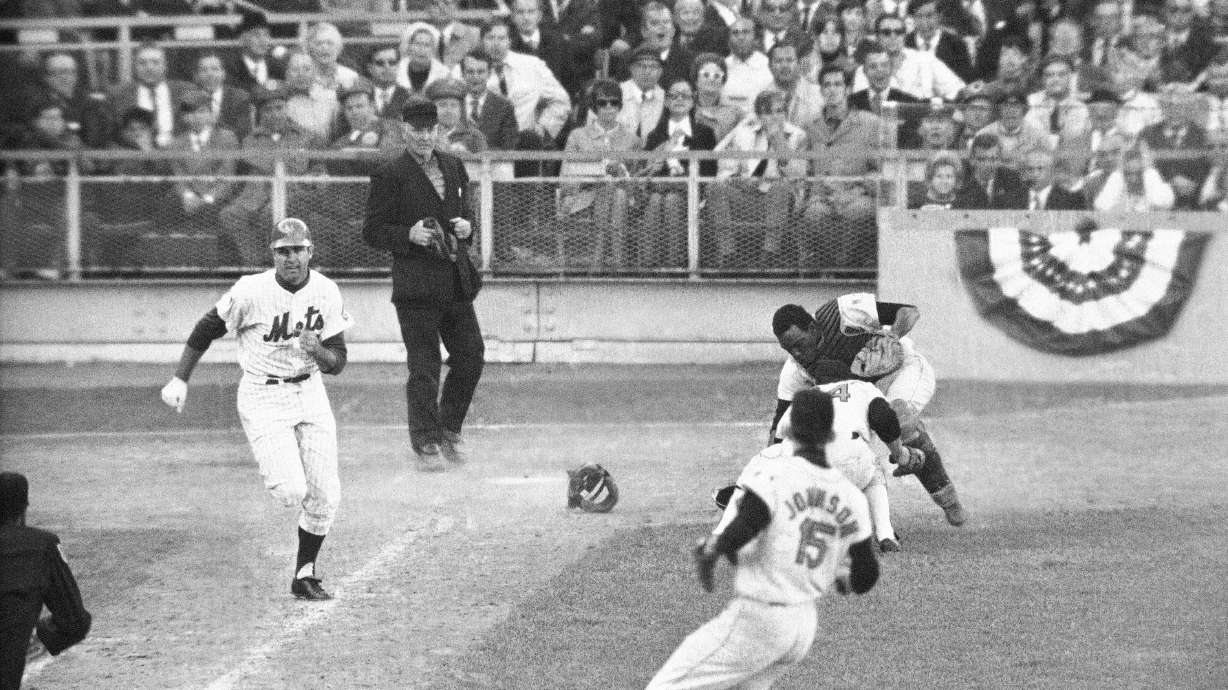 FILE -Orioles catcher Ellie Hendricks and pitcher Pete Richert reach for bunt laid down by J.C. Martin in tenth inning of game 4 of the World Series baseball game Oct. 15, 1969 in New York. Richert fielded it and his throw to Dave Johnson hit Martin in back and bounded away, enabling Rod Gaspar to score from second. Umpire is Shag Crawford. Major League Baseball is widening the runner's lane approaching first base to include a portion of fair territory, shortening the pitcher's clock with runners on base by two seconds to 18 and further reducing mound visits in an effort to further speed games next season.