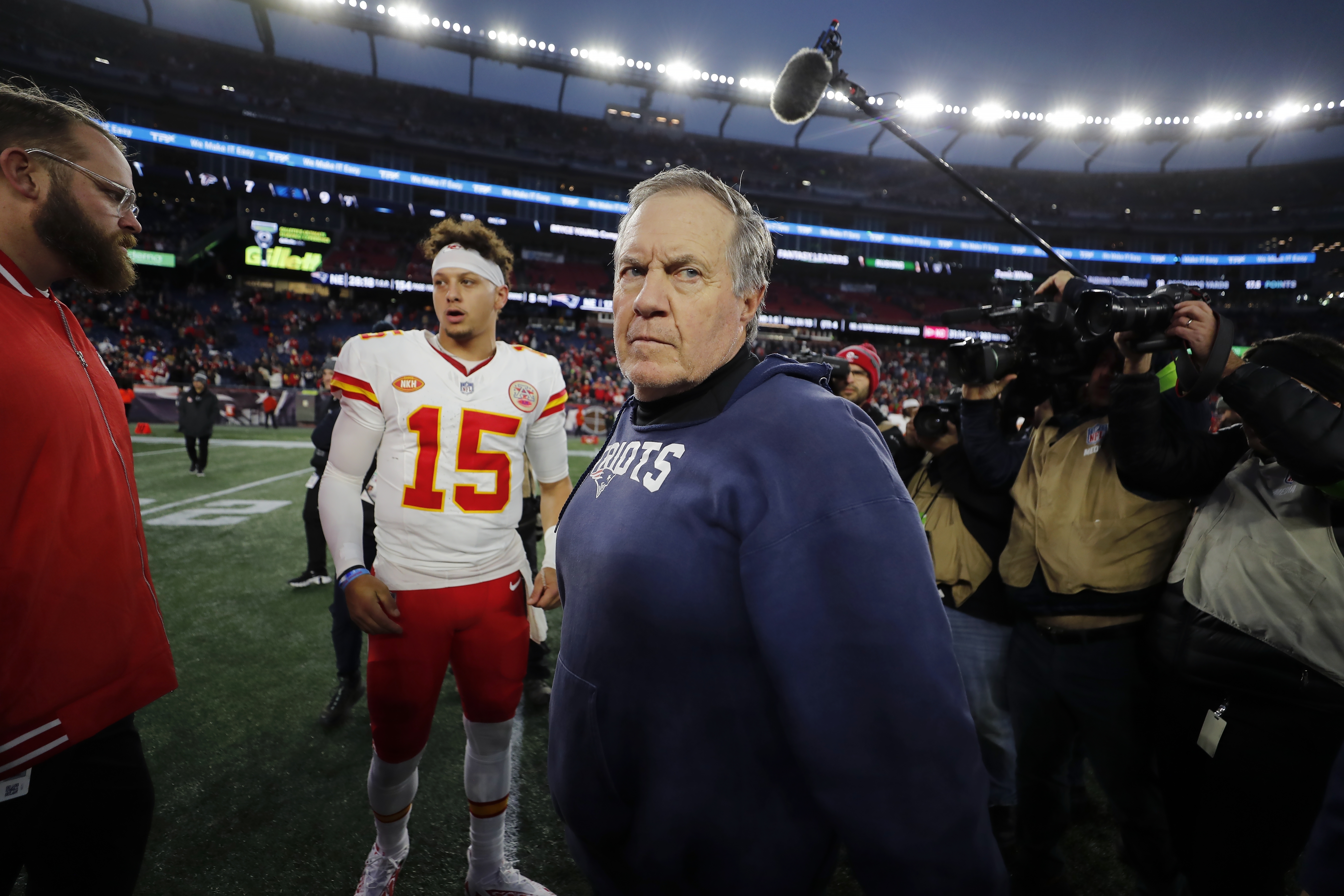 New England Patriots head coach Bill Belichick, center, turns away after shaking hands with Kansas City Chiefs quarterback Patrick Mahomes (15) following an NFL football game, Sunday, Dec. 17, 2023, in Foxborough, Mass.