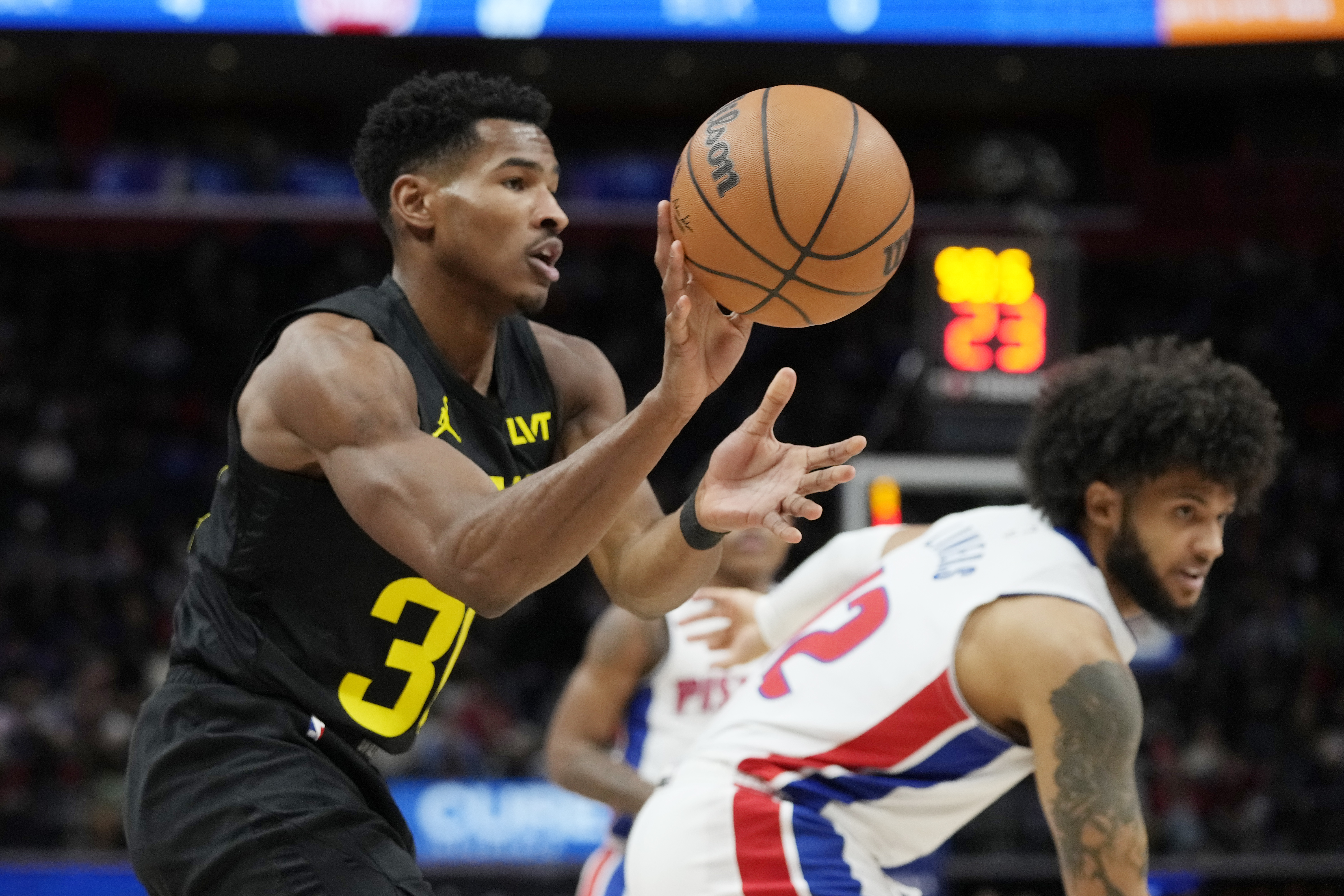 Utah Jazz guard Ochai Agbaji grabs a rebound during the first half of an NBA basketball game against the Detroit Pistons, Thursday, Dec. 21, 2023, in Detroit.