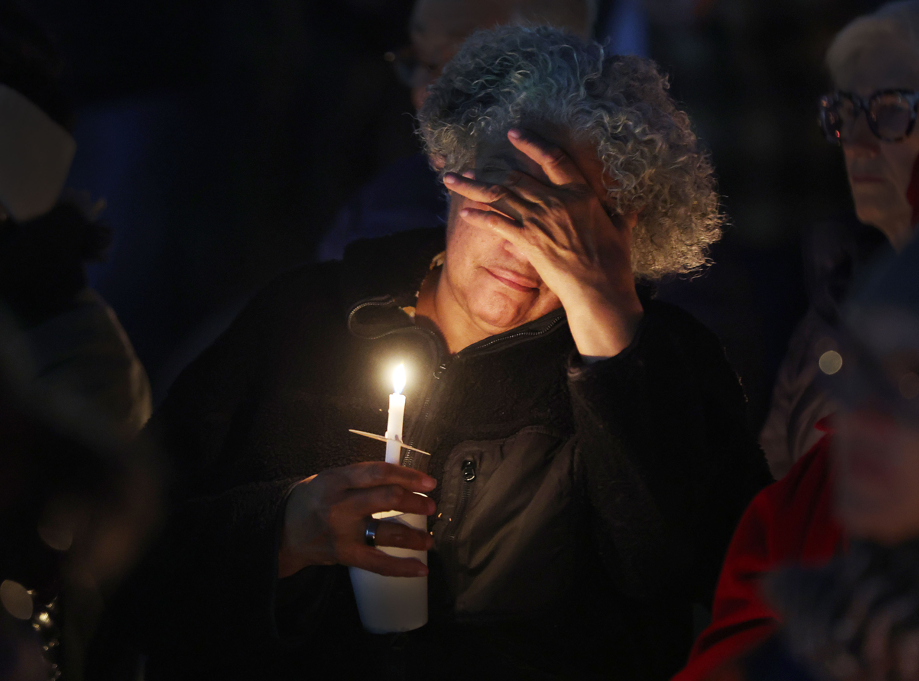 Christine Diniz mourns the loss of her son's friend during the Homeless Persons’ Memorial Vigil in Pioneer Park in Salt Lake City on Thursday.