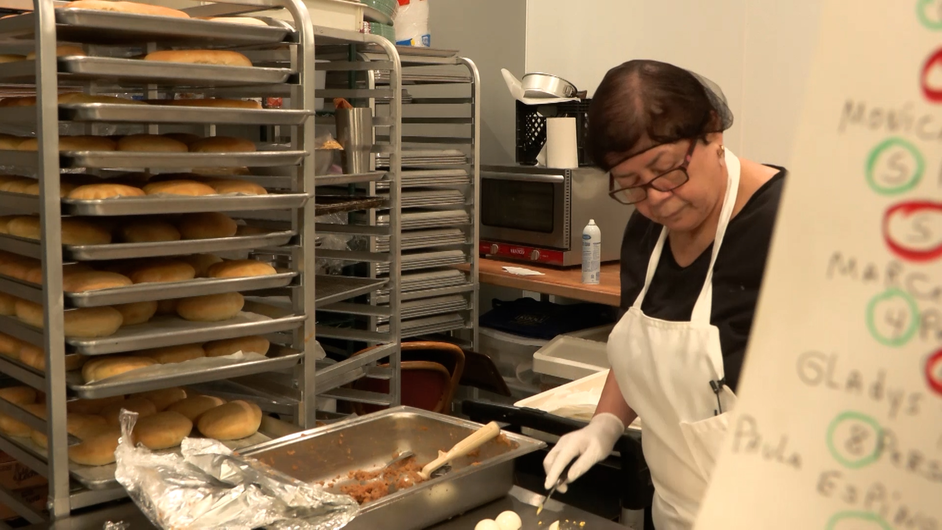 Noemi Bustamante prepares some empanadas this week at her Midvale cafe.