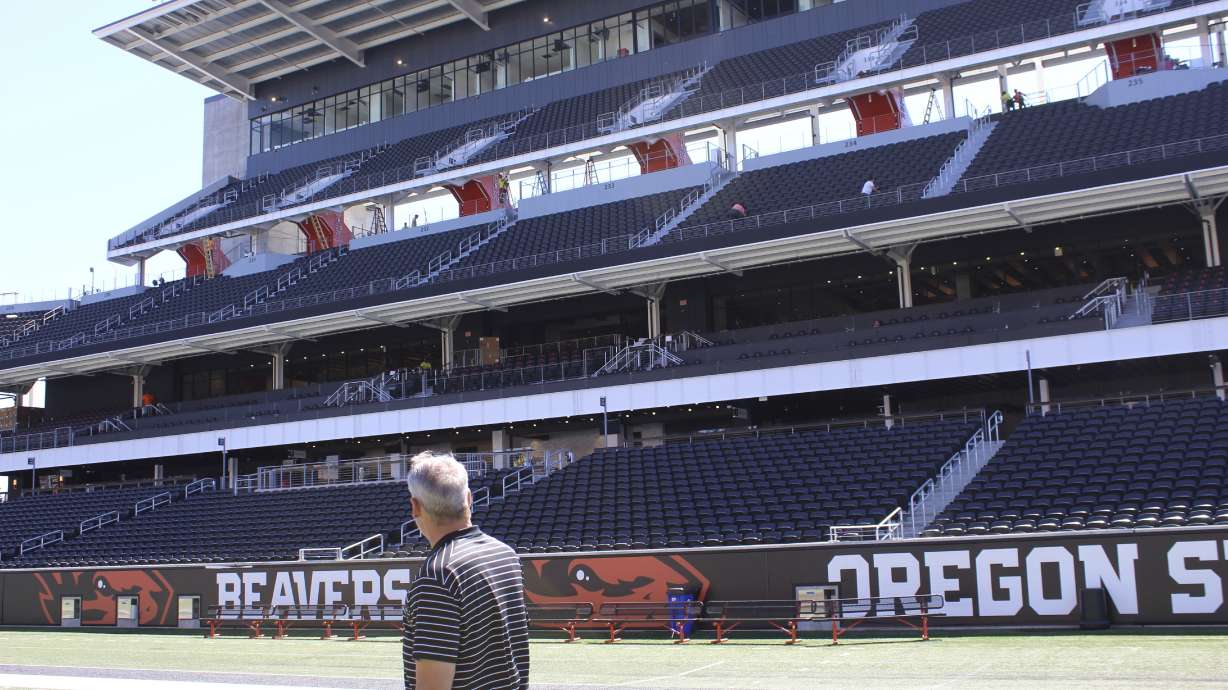 Oregon State athletic director Scott Barnes looks at the renovated side of Reser Stadium on Tuesday, Aug. 8, 2023, in Corvallis, Ore. The Pac-12 was ripped apart and redistributed by its competitors, regardless of geography. The stunning demolition, set in motion a year earlier, was accelerated when the Pac-12 couldn’t secure a media rights deal to match its competitors.
