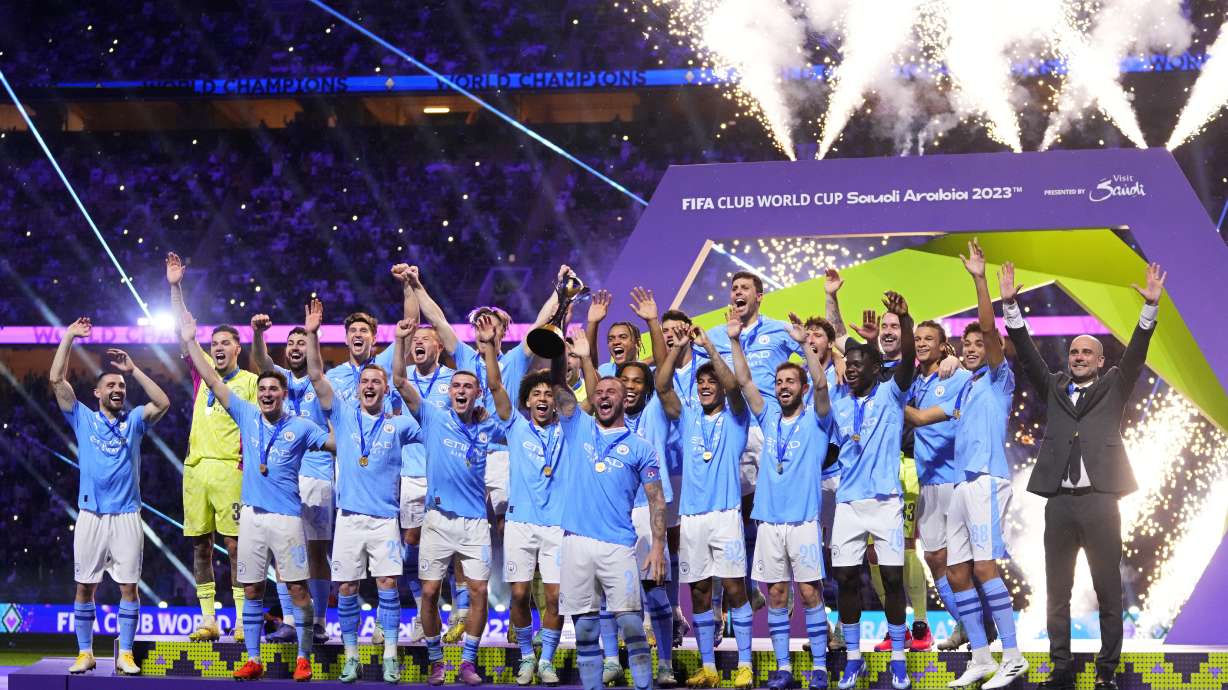 Manchester City's Kyle Walker, center, lifts the trophy at the end of the Soccer Club World Cup final match between Manchester City FC and Fluminense FC at King Abdullah Sports City Stadium in Jeddah, Saudi Arabia, Friday, Dec. 22, 2023. Manchester City won 4-0.