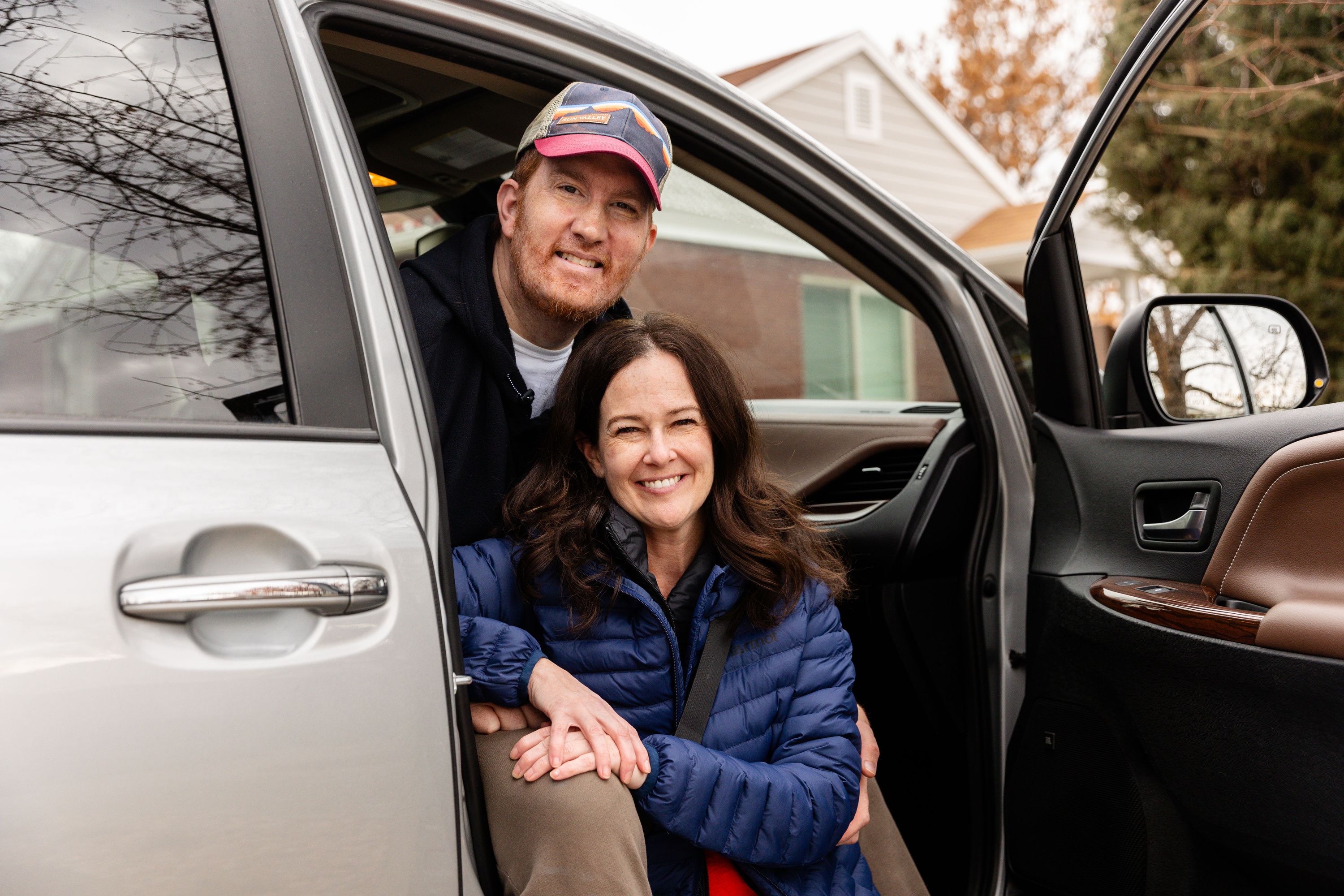 Whitney and Sean Cunningham smile for a portrait in their new van outside their home in Salt Lake City on Wednesday. The van offers features that accommodate Sean’s wheelchair.