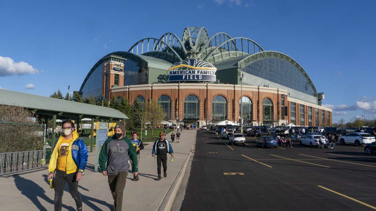 FILE - Fans are pictured outside American Family Field before a baseball game between the Milwaukee Brewers and the Chicago Cubs, April 12, 2021, in Milwaukee. Proposals for new and improved sports stadiums are proliferating across the U.S. — and could come with a hefty price tag for taxpayers.