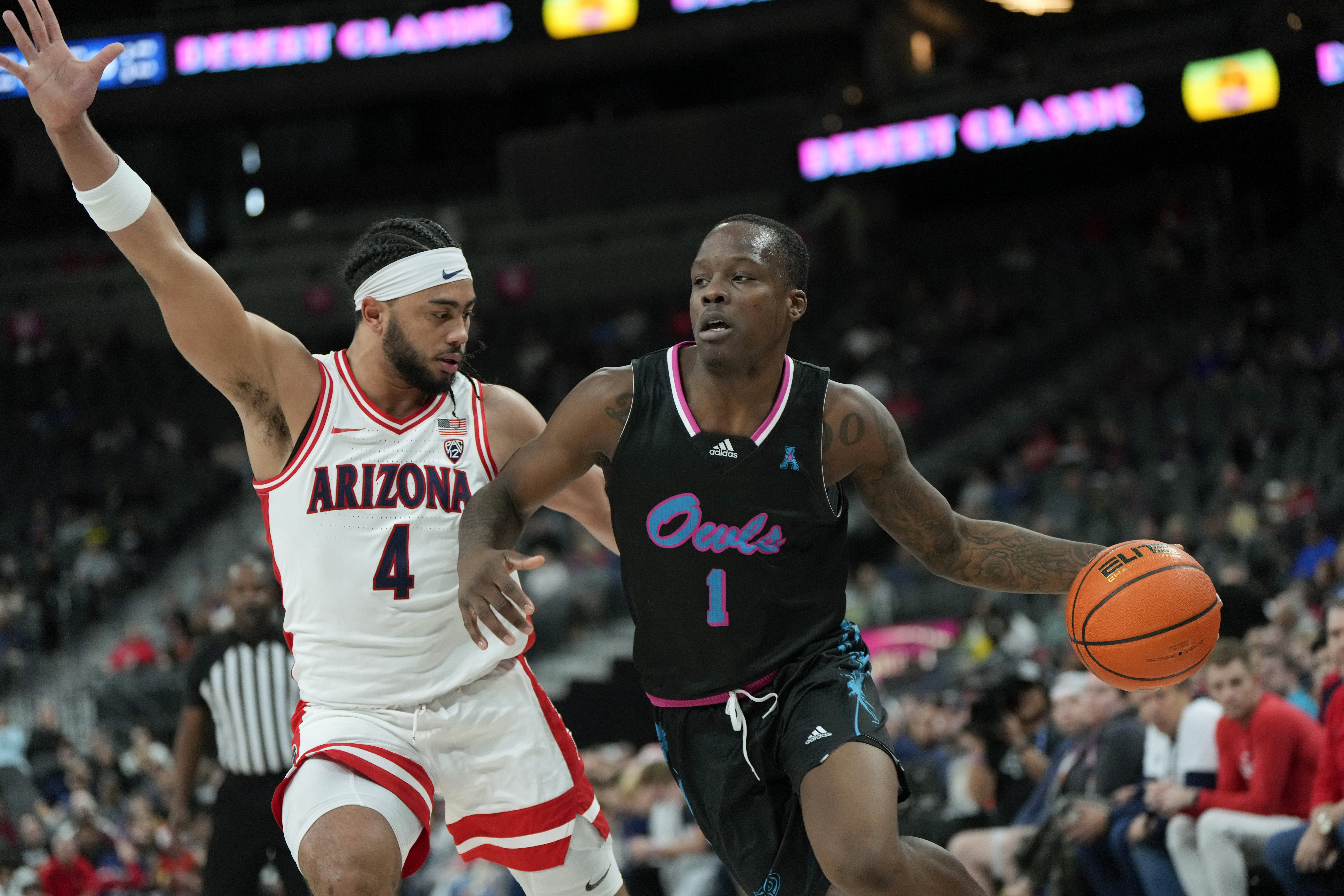 Florida Atlantic guard Johnell Davis (1) drives the ball against Arizona guard Kylan Boswell (4) during the first half of an NCAA college basketball game Saturday, Dec. 23, 2023, in Las Vegas.