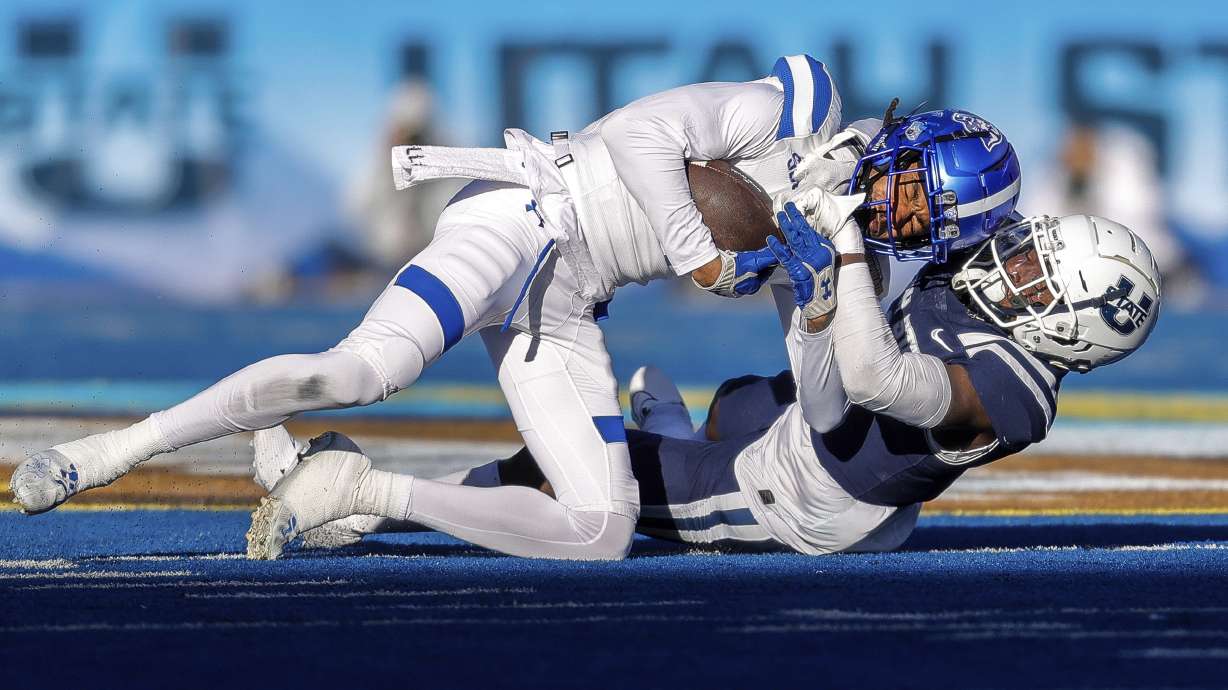 Georgia State wide receiver Cadarrius Thompson, top, is tackled after a reception by Utah State safety Ike Larsen in the first half of the Famous Idaho Potato Bowl NCAA college football game, Saturday, Dec. 23, 2023, in Boise, Idaho.