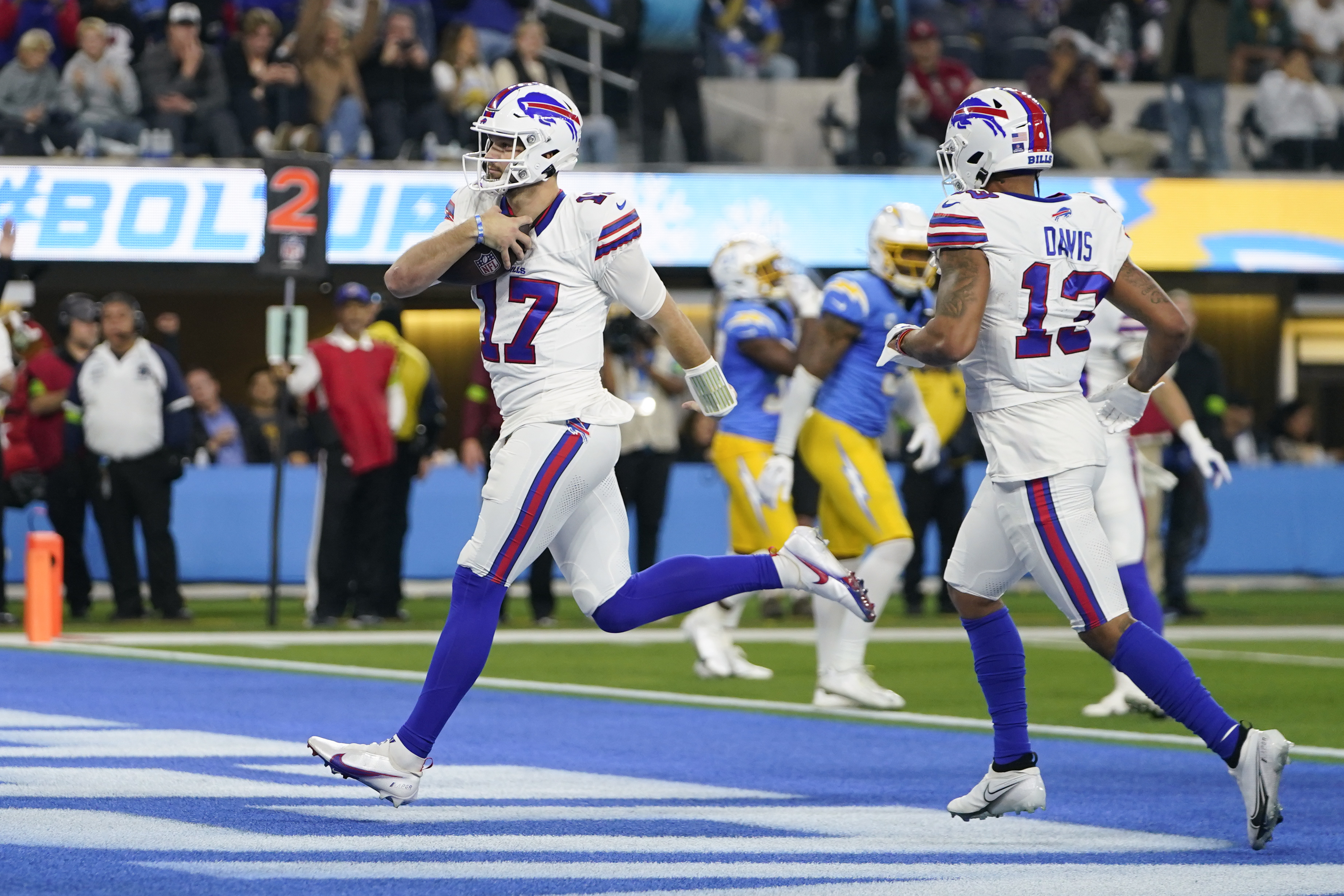 Buffalo Bills quarterback Josh Allen (17) scores a rushing touchdown during the first half of an NFL football game against the Los Angeles Chargers, Saturday, Dec. 23, 2023, in Inglewood, Calif.