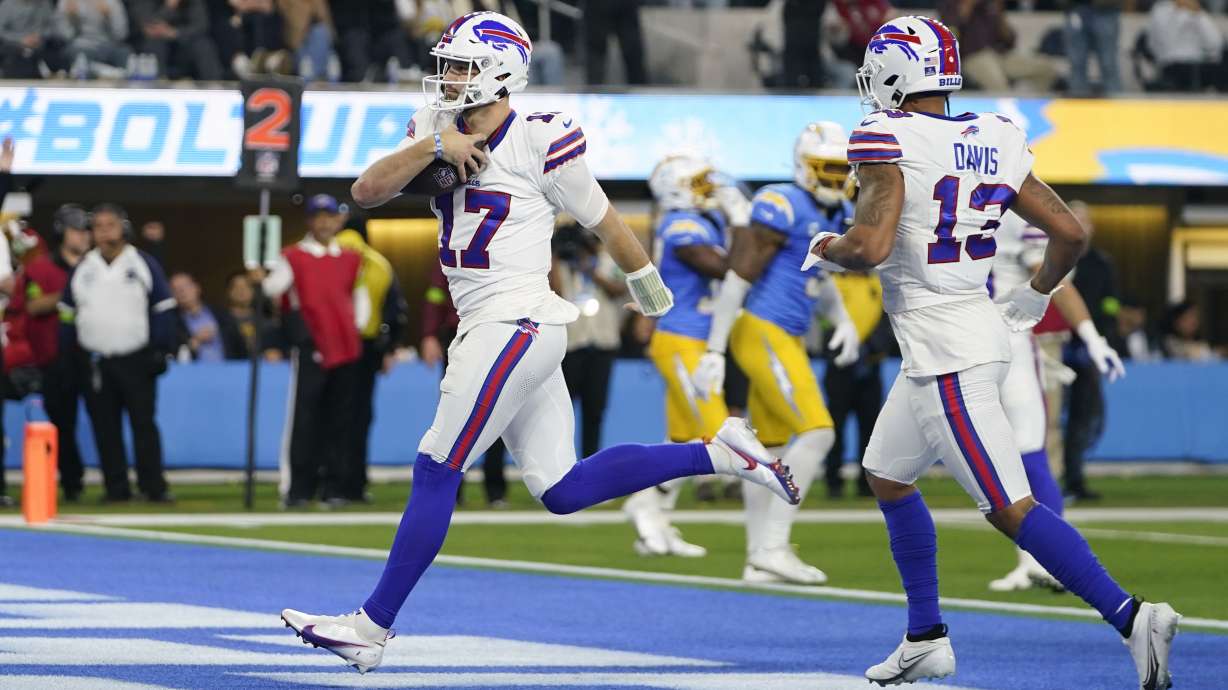 Buffalo Bills quarterback Josh Allen (17) scores a rushing touchdown during the first half of an NFL football game against the Los Angeles Chargers, Saturday, Dec. 23, 2023, in Inglewood, Calif.