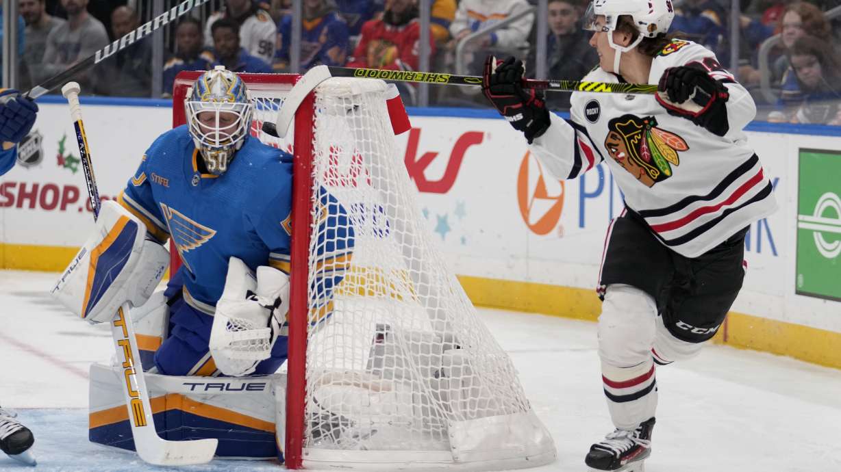Chicago Blackhawks' Connor Bedard, right, scores past St. Louis Blues goaltender Jordan Binnington during the first period of an NHL hockey game Saturday, Dec. 23, 2023, in St. Louis.