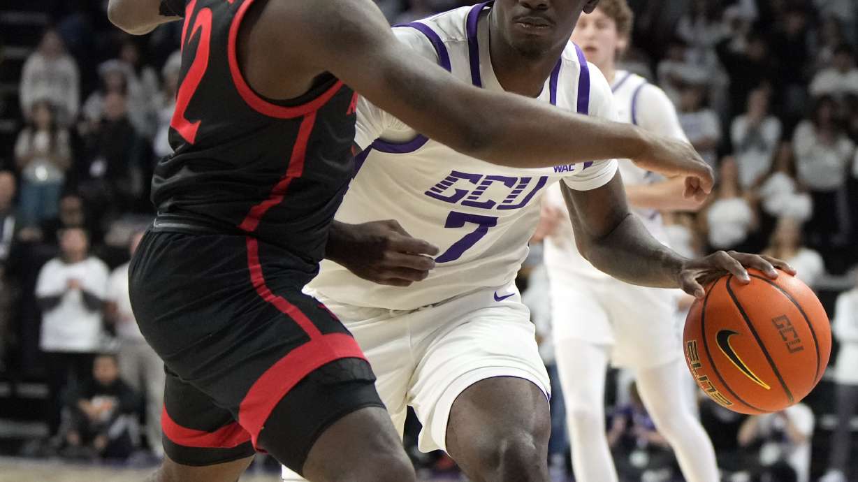 Grand Canyon guard Tyon Grant-Foster drives on Grand Canyon guard Marquese Josephs (12) during the second half of an NCAA college basketball game Tuesday, Dec. 5, 2023, in Phoenix.