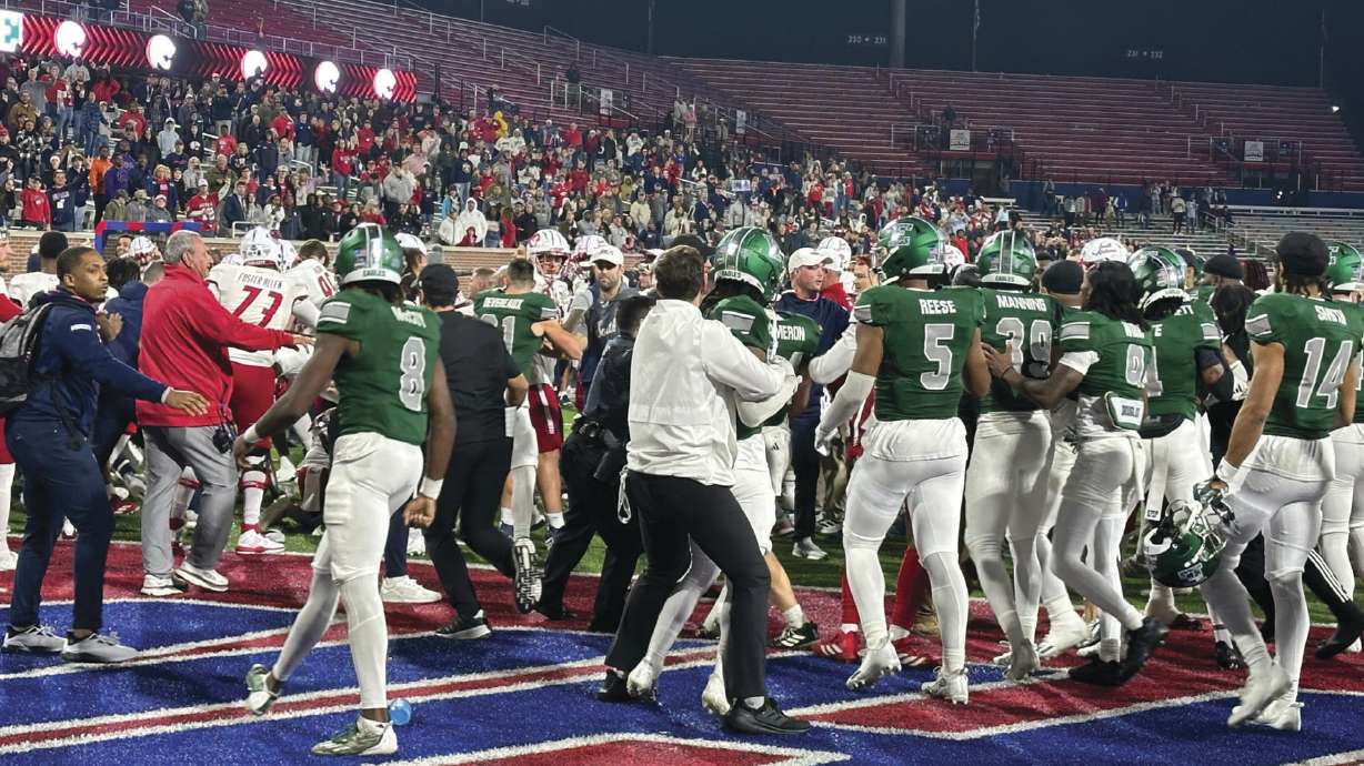 People react to a brawl that ensued following the 68 Ventures Bowl NCAA college football game between South Alabama and Eastern Michigan, Saturday, Dec. 23, 2023, in Mobile, Ala.