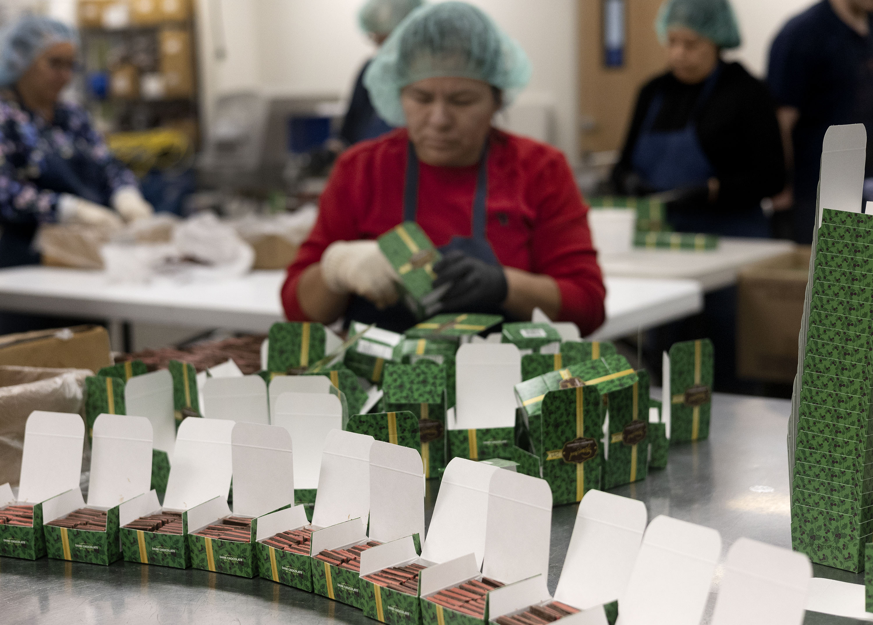 Chocolate sandwiches are hand packed into boxes at Fernwood Candy Company in Logan on Nov. 30.