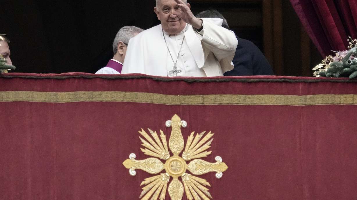 Pope Francis waves before delivering the Urbi et Orbi (Latin for 'to the city and to the world' ) Christmas' day blessing from the main balcony of St. Peter's Basilica at the Vatican on Monday.