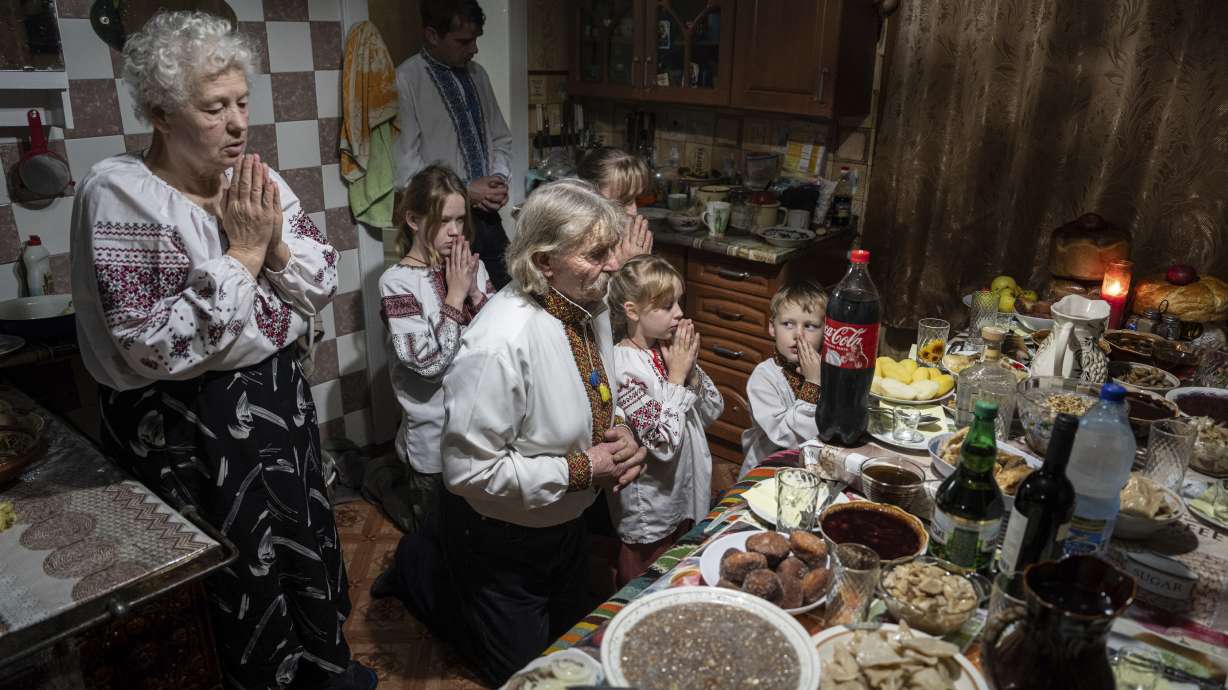 The Zelenchuk family prays before a Christmas dinner in Kryvorivnia village, Ukraine, on Sunday.