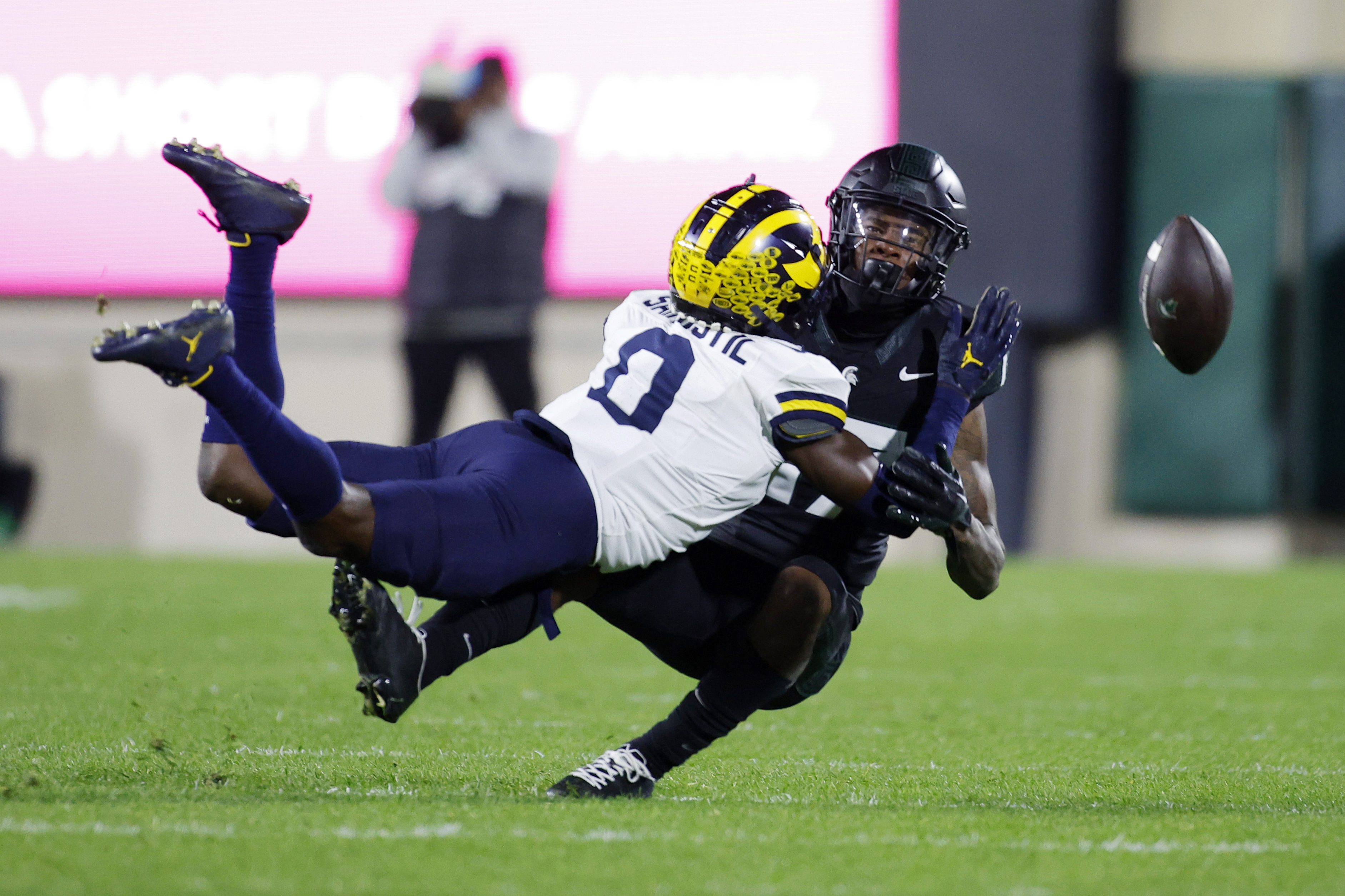 FILE - Michigan defensive back Mike Sainristil, left, breaks up a pass intended for Michigan State wide receiver Tre Mosley during the first half of an NCAA college football game, Saturday, Oct. 21, 2023, in East Lansing, Mich. Sainristil will lead the top-ranked Wolverines into their New Year's Day matchup with Alabama in the Rose Bowl. 