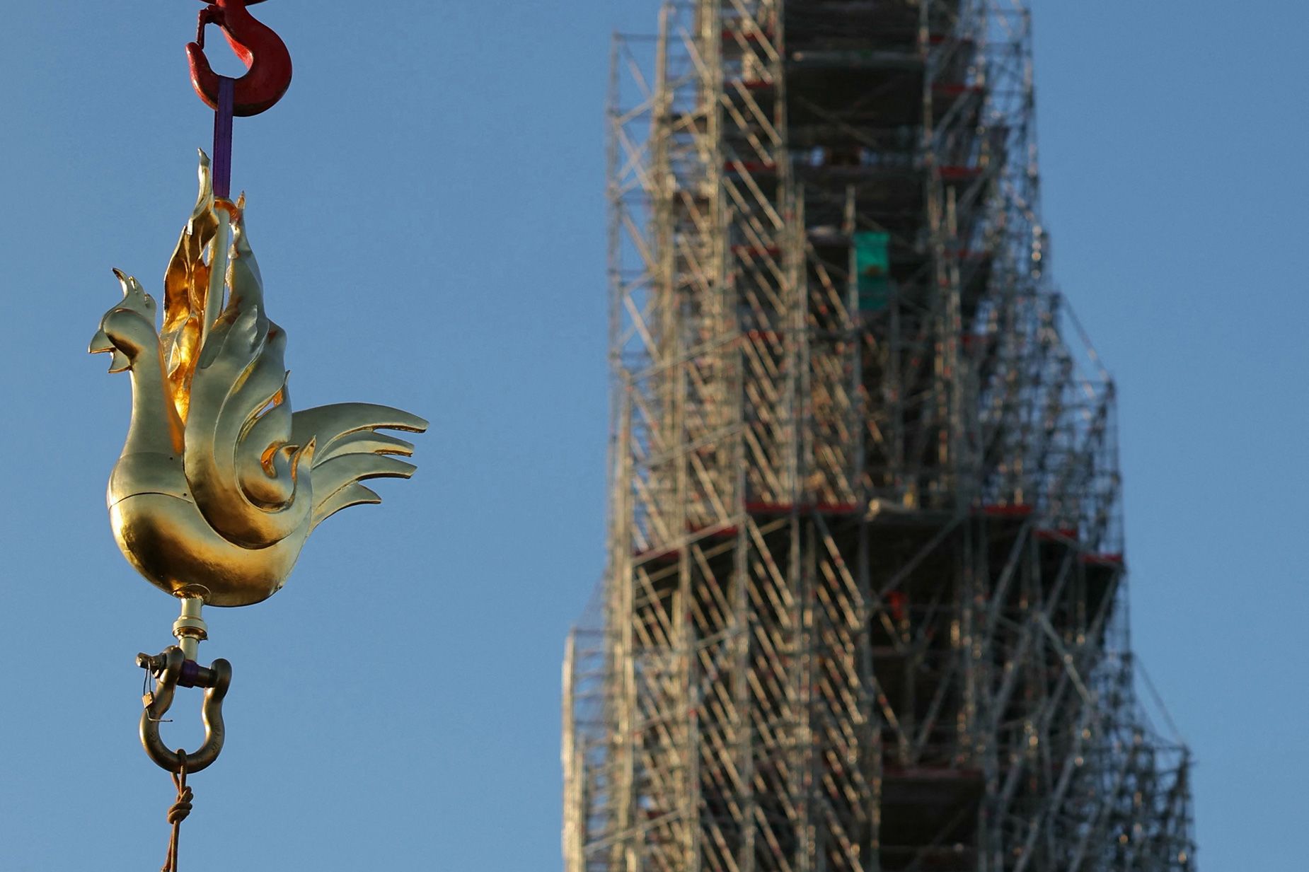 The spire's new golden rooster, designed by architect Philippe Villeneuve, contains relics saved from the fire that struck the monument on April 15, 2019, and a document with the names of those working on its reconstruction.