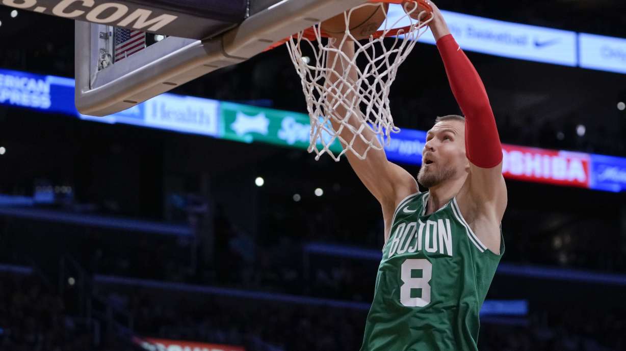 Boston Celtics center Kristaps Porzingis dunks the ball during the first half of an NBA basketball game against the Los Angeles Lakers, Monday, Dec. 25, 2023, in Los Angeles.